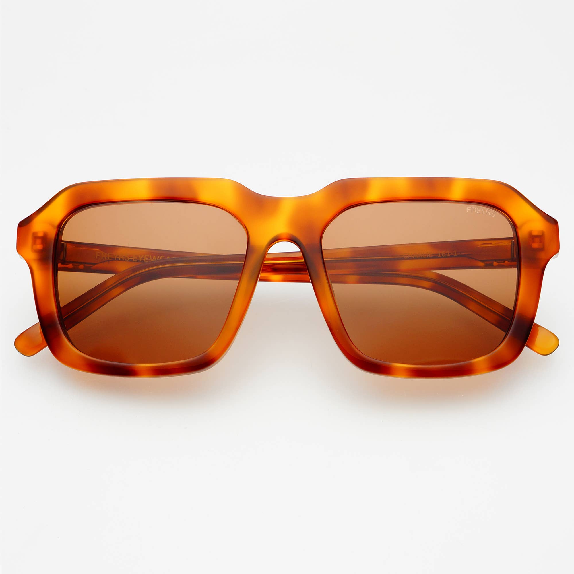 Front view of FREYRS Eyewear’s Charlie Acetate Unisex Rectangular Sunglasses, featuring a bold tortoiseshell handmade acetate frame and brown tinted UVA/UVB-protective lenses, set against a plain white background.
