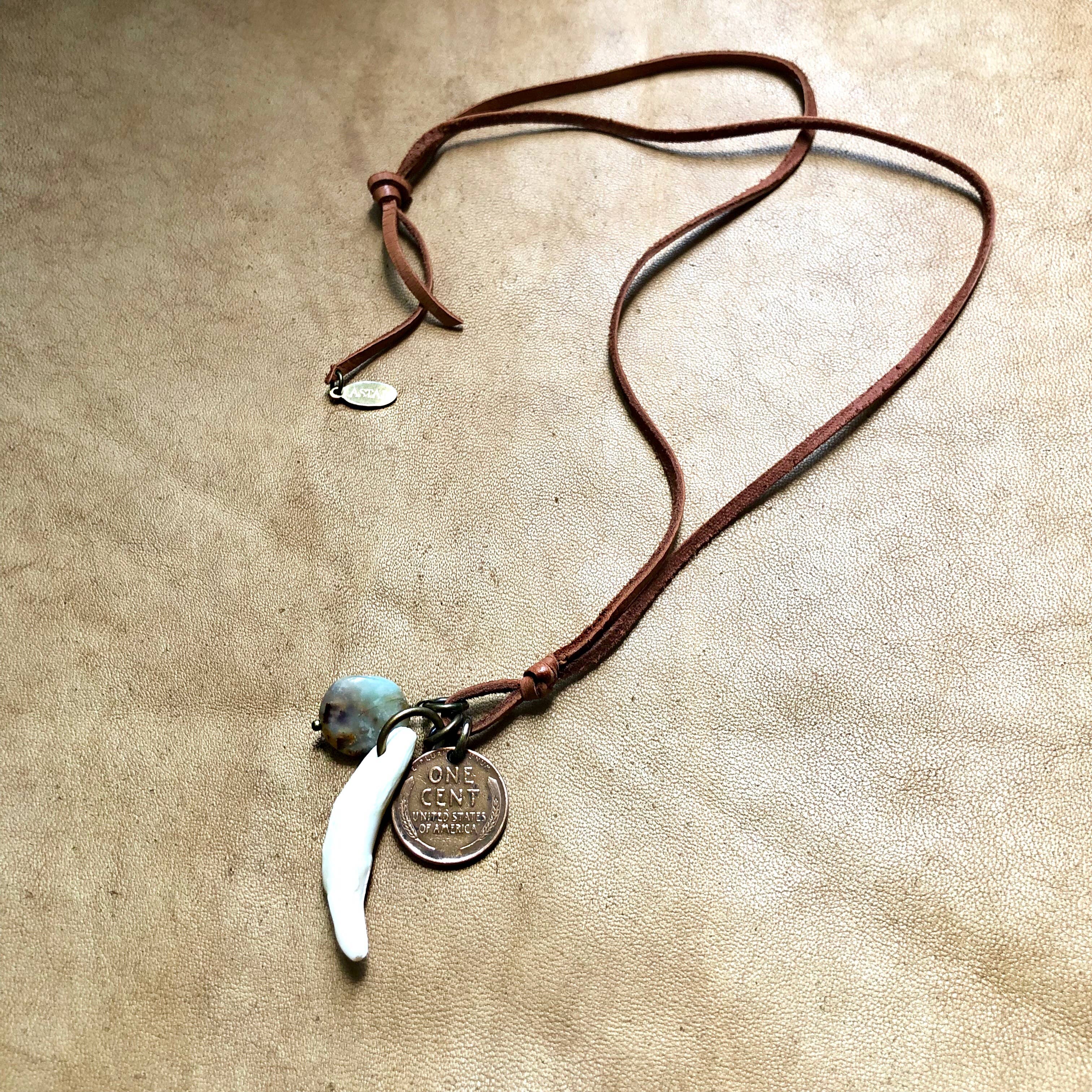 Coyote Tooth & Blue Opal Necklace, Wheat Penny, Rust Leather with rustic charm on a textured background