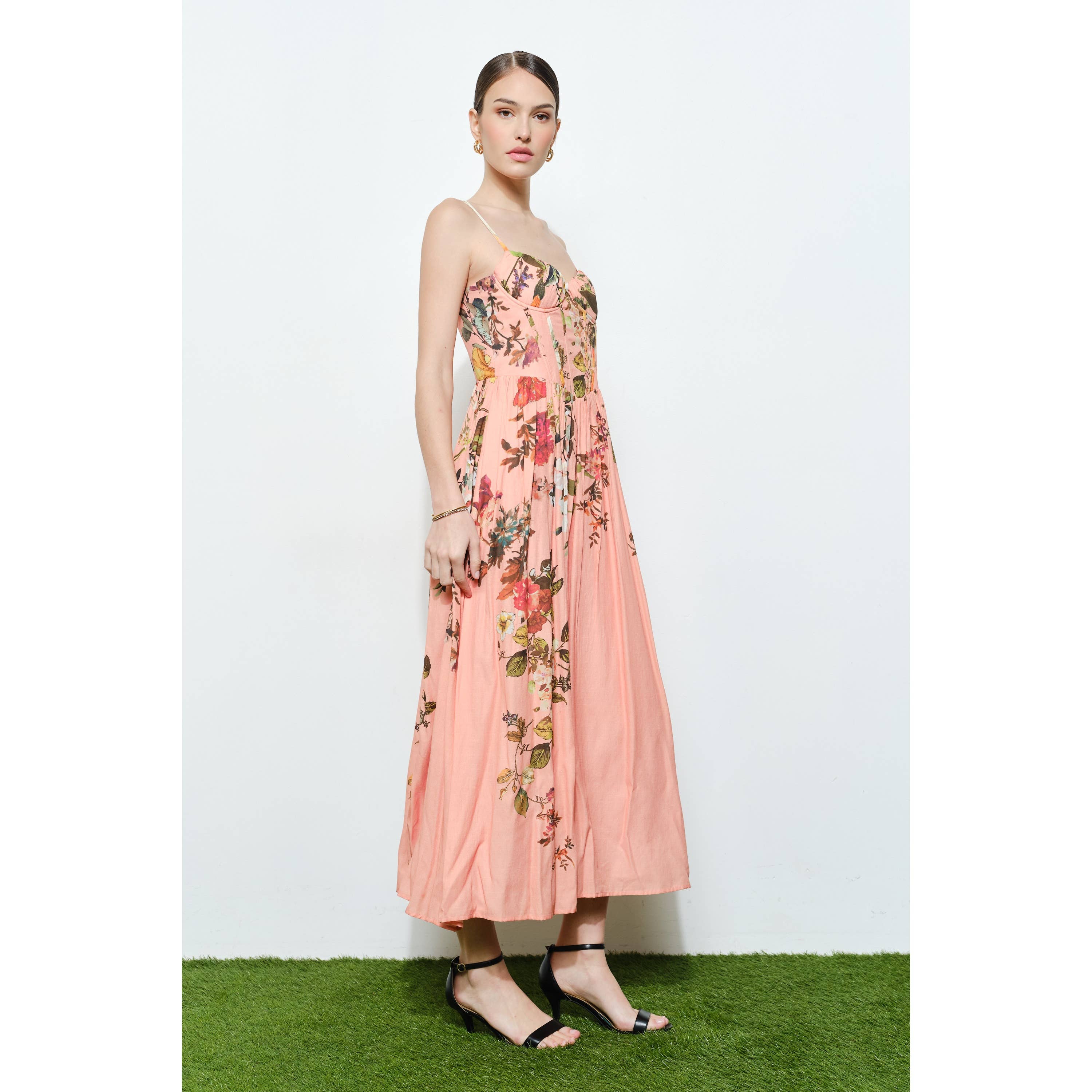Model wearing a flowing Vintage Floral Sweetheart Maxi Dress in soft pink with delicate floral prints and thin straps
