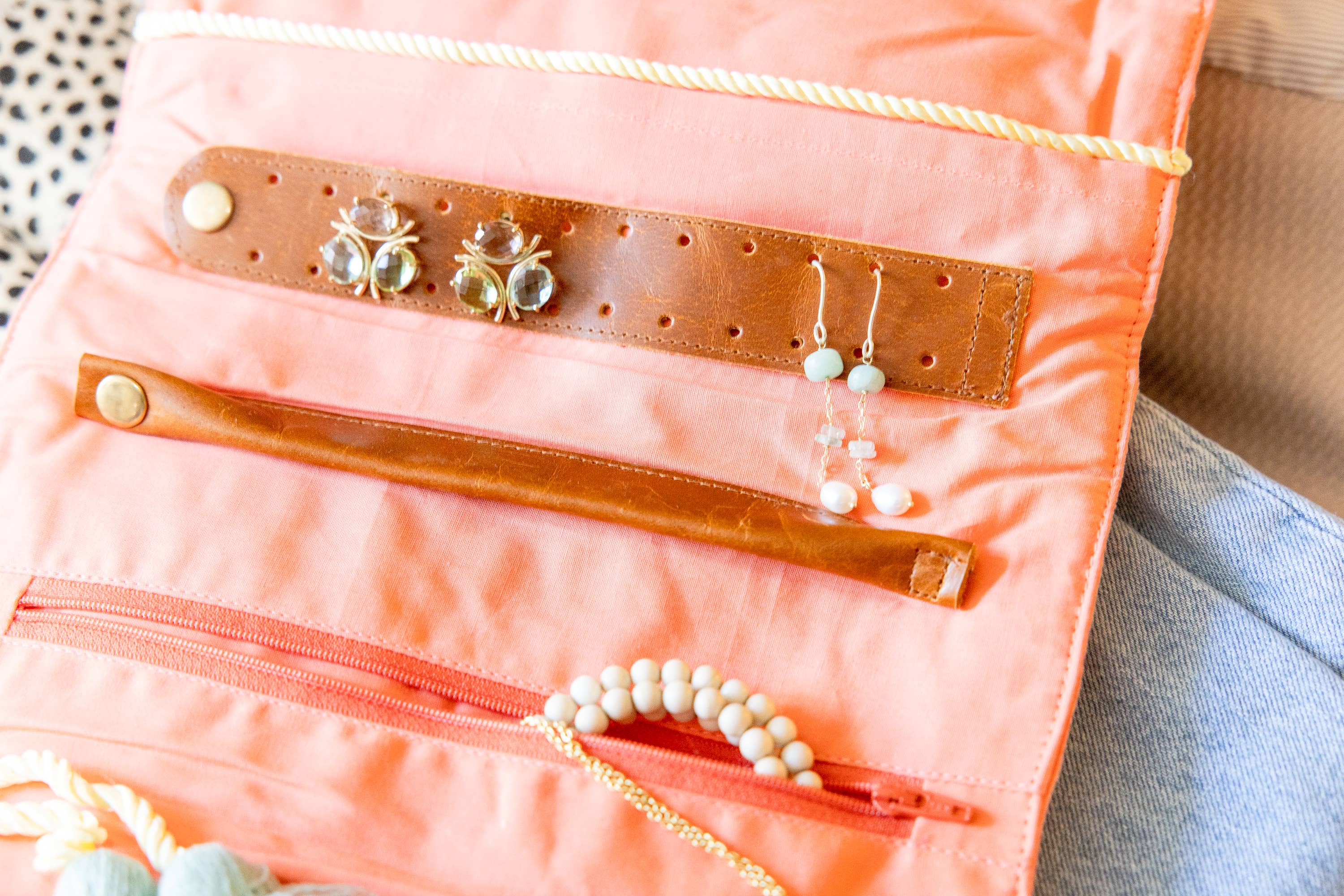 Embroidered Velvet Jewelry Organizer-Coral showcasing soft coral velvet with leather strap and compartments for earrings and bracelets