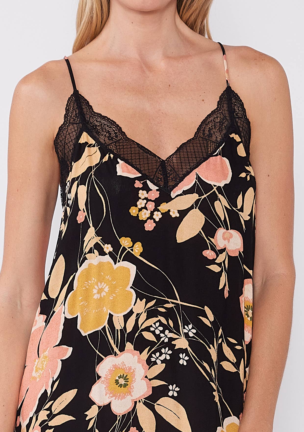 Close-up of a Floral Lace Trim Racerback Maxi Dress featuring delicate lace and soft floral patterns on black fabric.