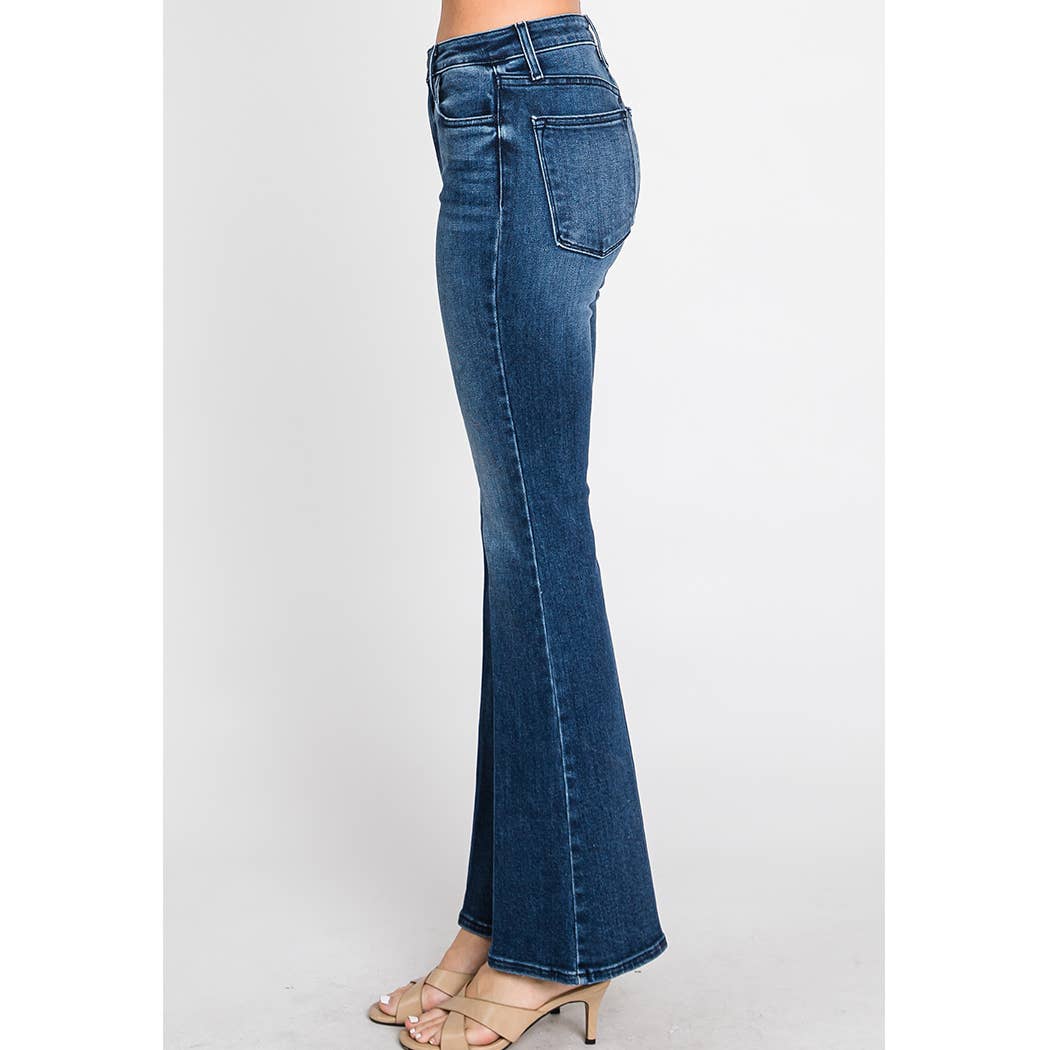 Side view of woman wearing Bella Whisker Flare Denim in a vintage-inspired dark wash with a high-rise fit and flare leg silhouette.