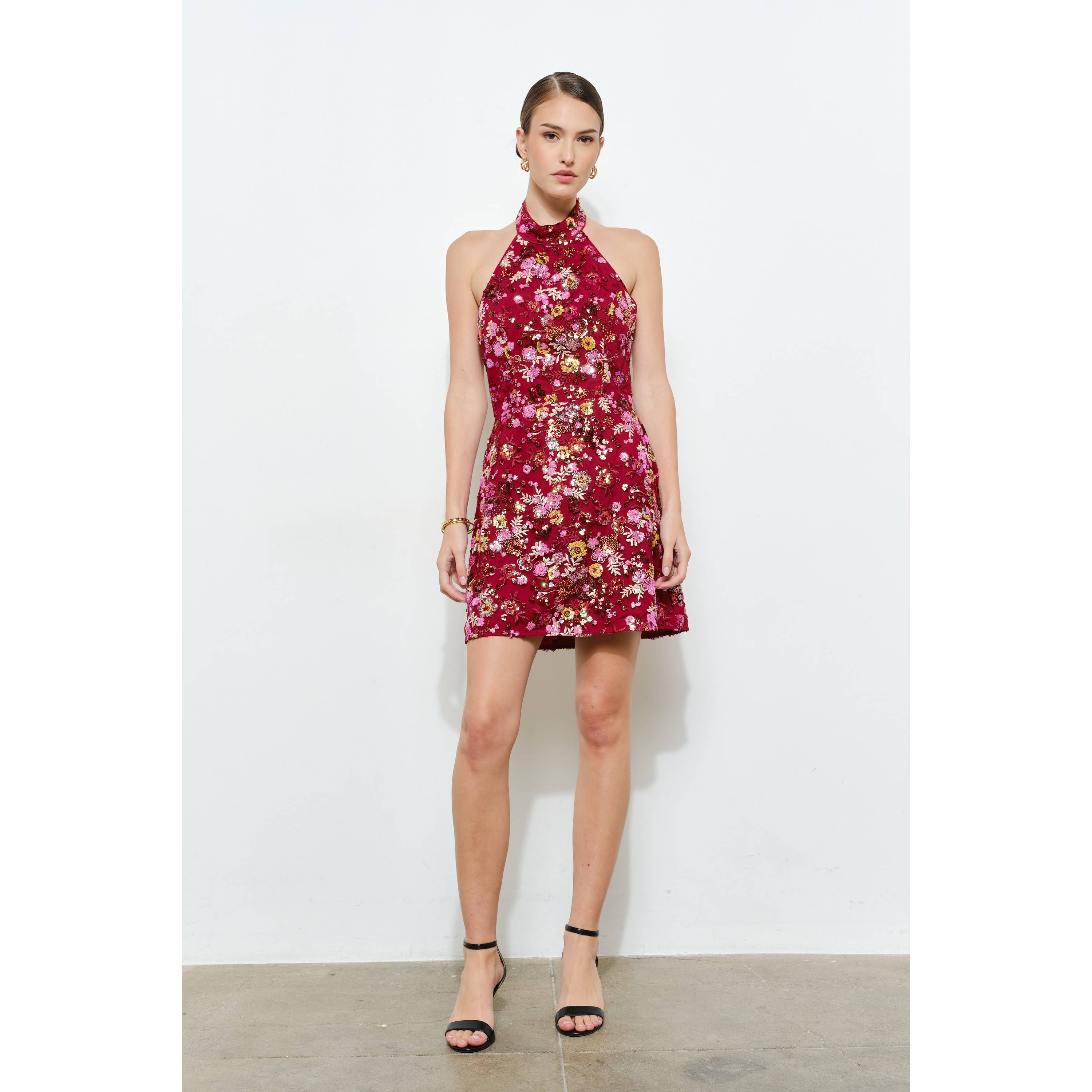 Model wearing a vibrant Floral Sequins Embellished Halter Neck Mini Dress with a sleek, fitted silhouette.