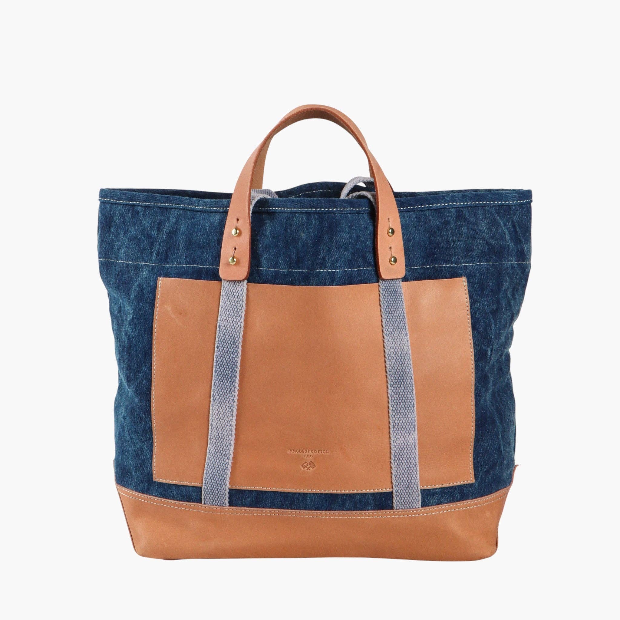Editor Tote | Indigo + Tan with durable indigo fabric, tan leather accents, and sturdy handles for stylish everyday use