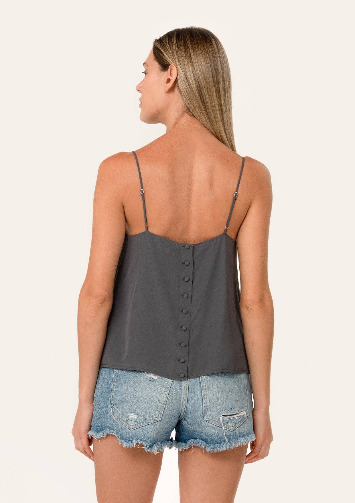 Woman wearing Button Back Embroidered Lace Cami in dark gray with thin straps and button details on back.