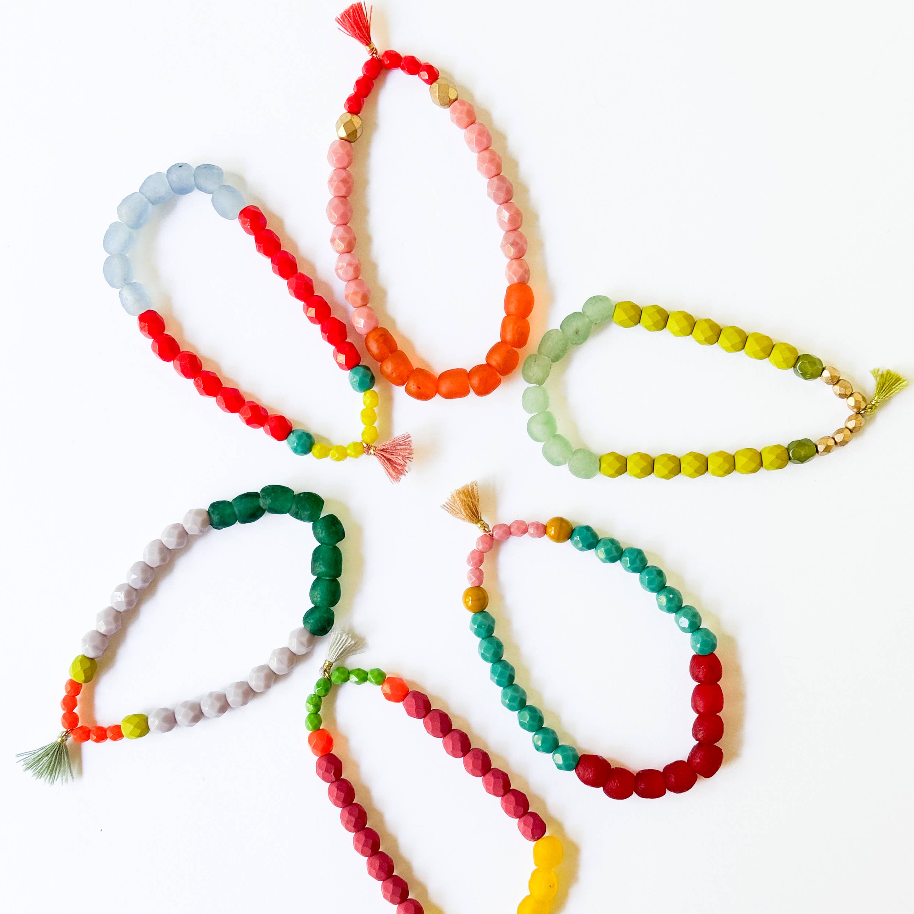 Multicolor Recycled African Glass And Mixed Bead Bracelet collection with vibrant, handcrafted beaded designs and tassel accents arranged in a circle