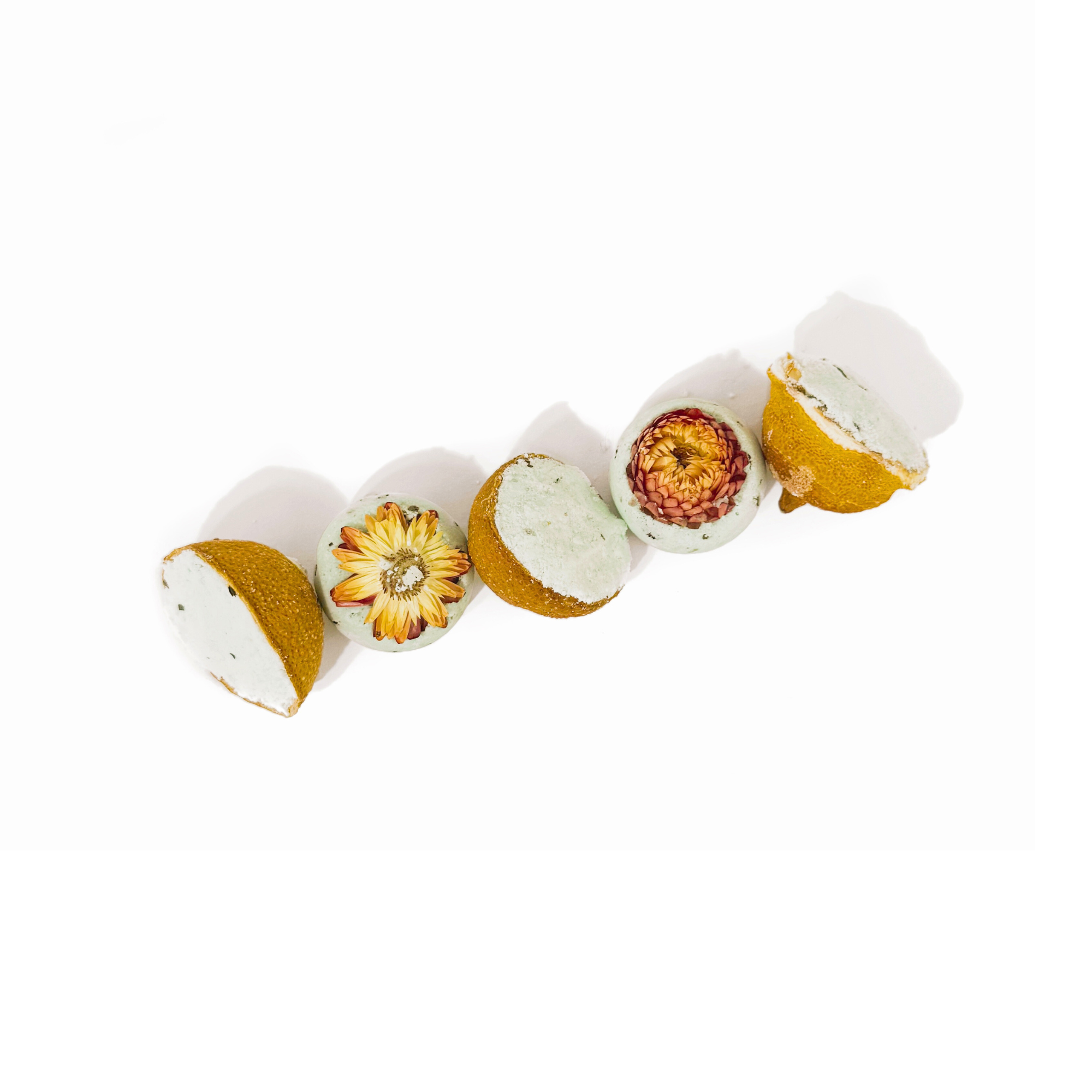 Natural Lemon Drop Bath Bomb Gift Set made with Lemon + MInt featuring dried flowers inside citrus halves on white background