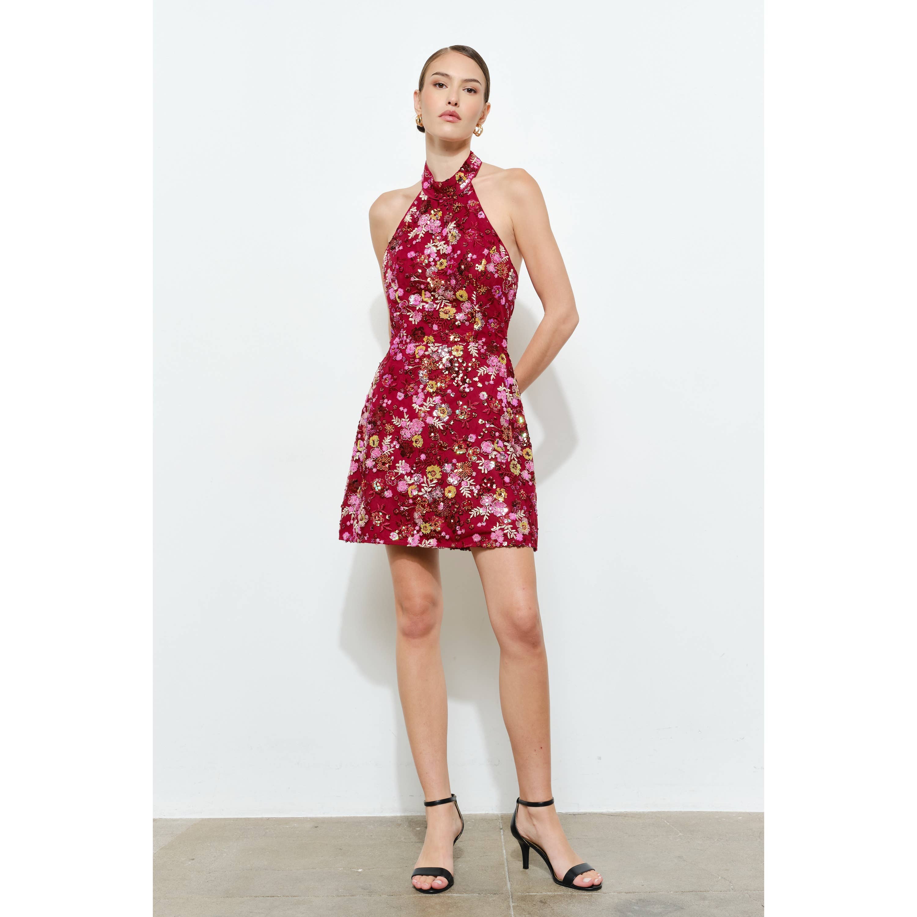 Model wearing a vibrant Floral Sequins Embellished Halter Neck Mini Dress with pink and red floral details