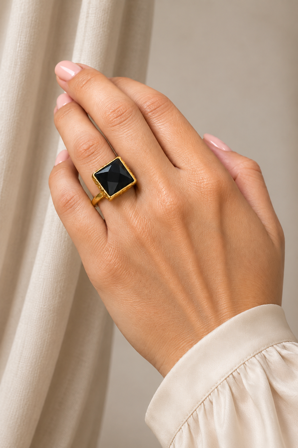 Siyah Onyx Ring with a faceted black stone and gold tone setting worn on hand