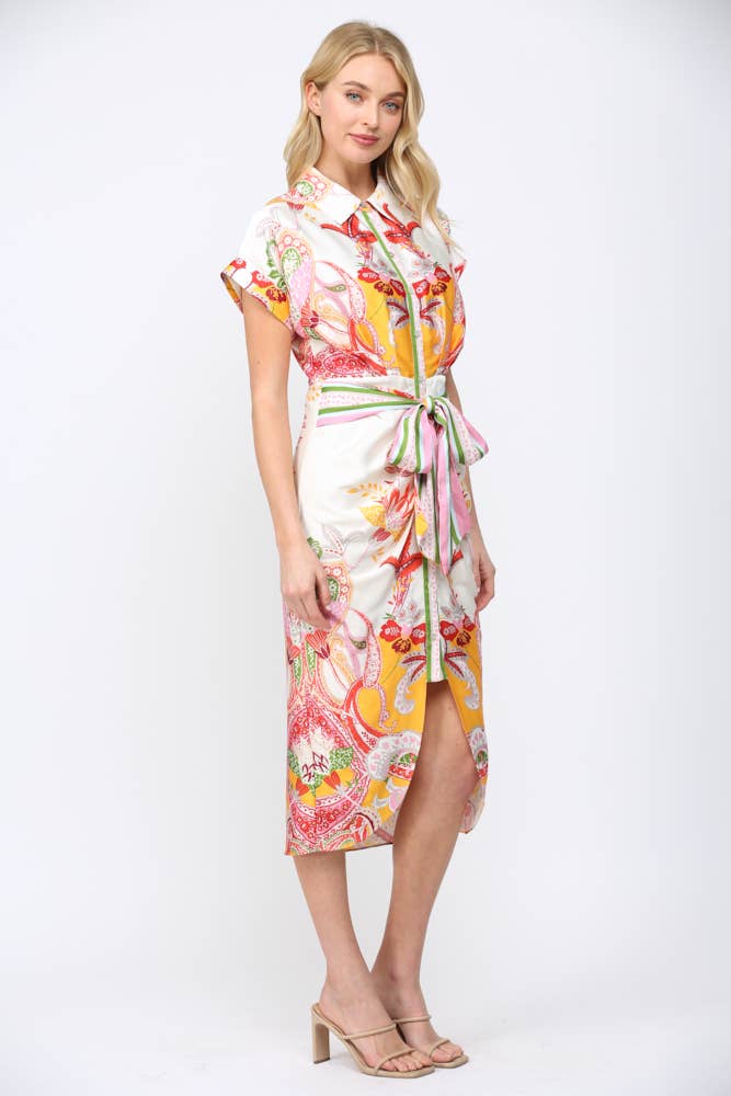 Woman wearing colorful BOTANIC SCARF PRINT SELF TIE WAIST BUTTON DOWN DRESS with floral and abstract patterns