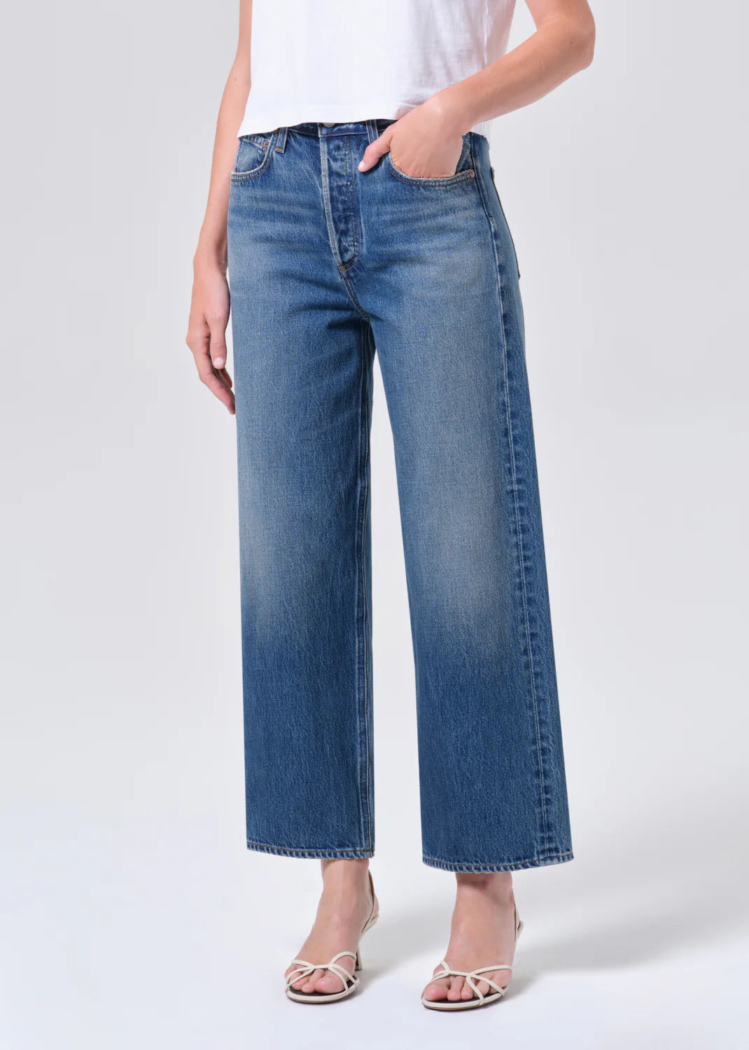 Woman wearing relaxed blue denim jeans and white top styled with white strappy heels REN JEAN in chapter