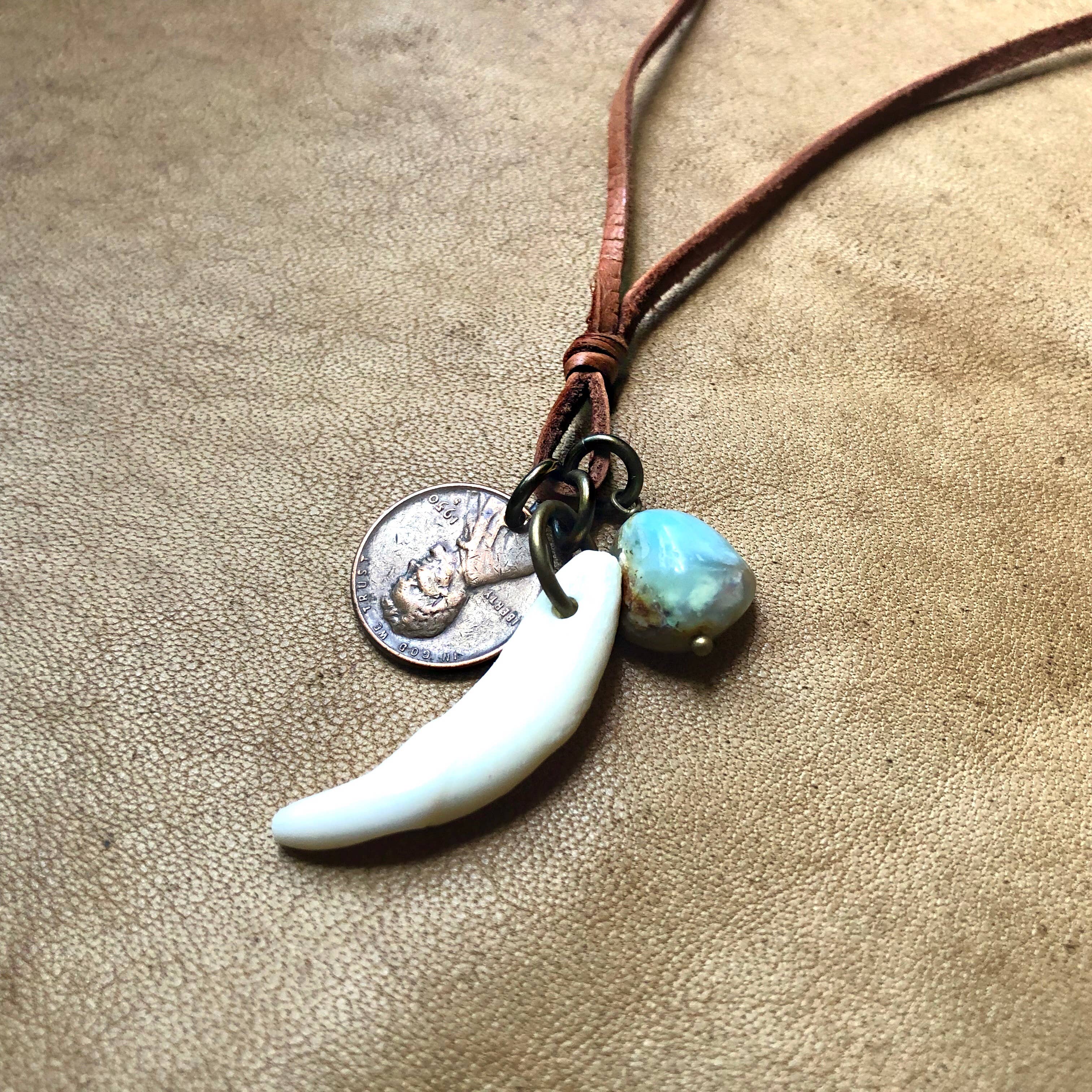 Coyote Tooth & Blue Opal Necklace, Wheat Penny, Rust Leather on textured brown leather background, boho style jewelry