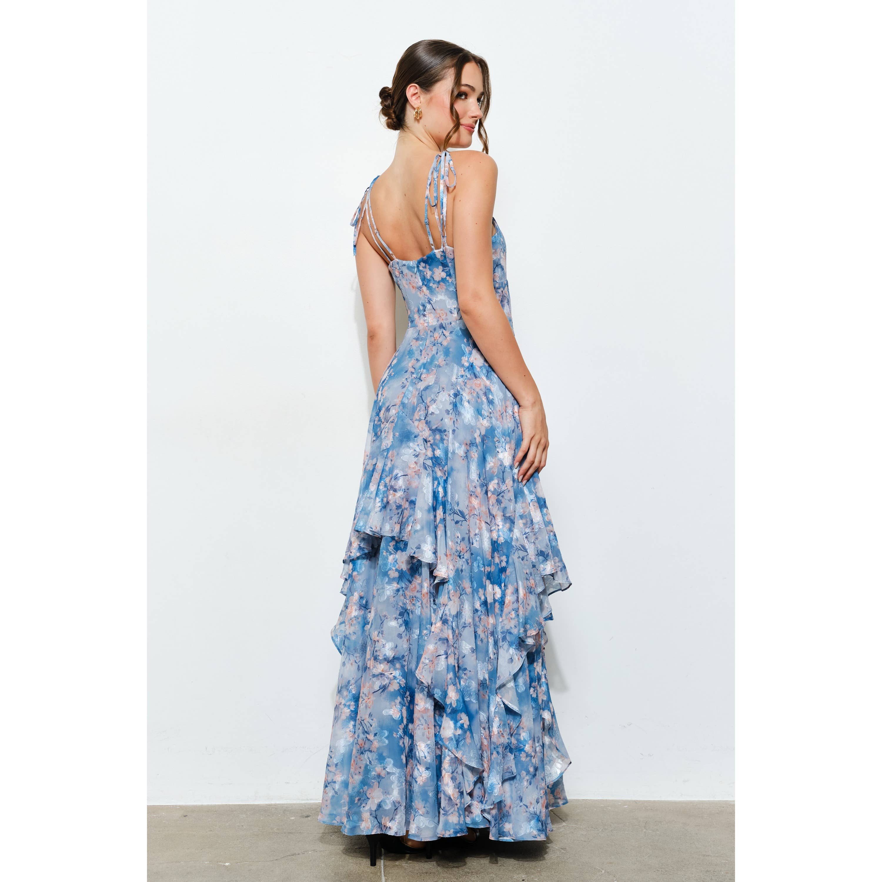 Woman in a flowing blue floral Romantic Floral Sweetheart Ruffled Maxi Dress with tie straps and layered ruffles