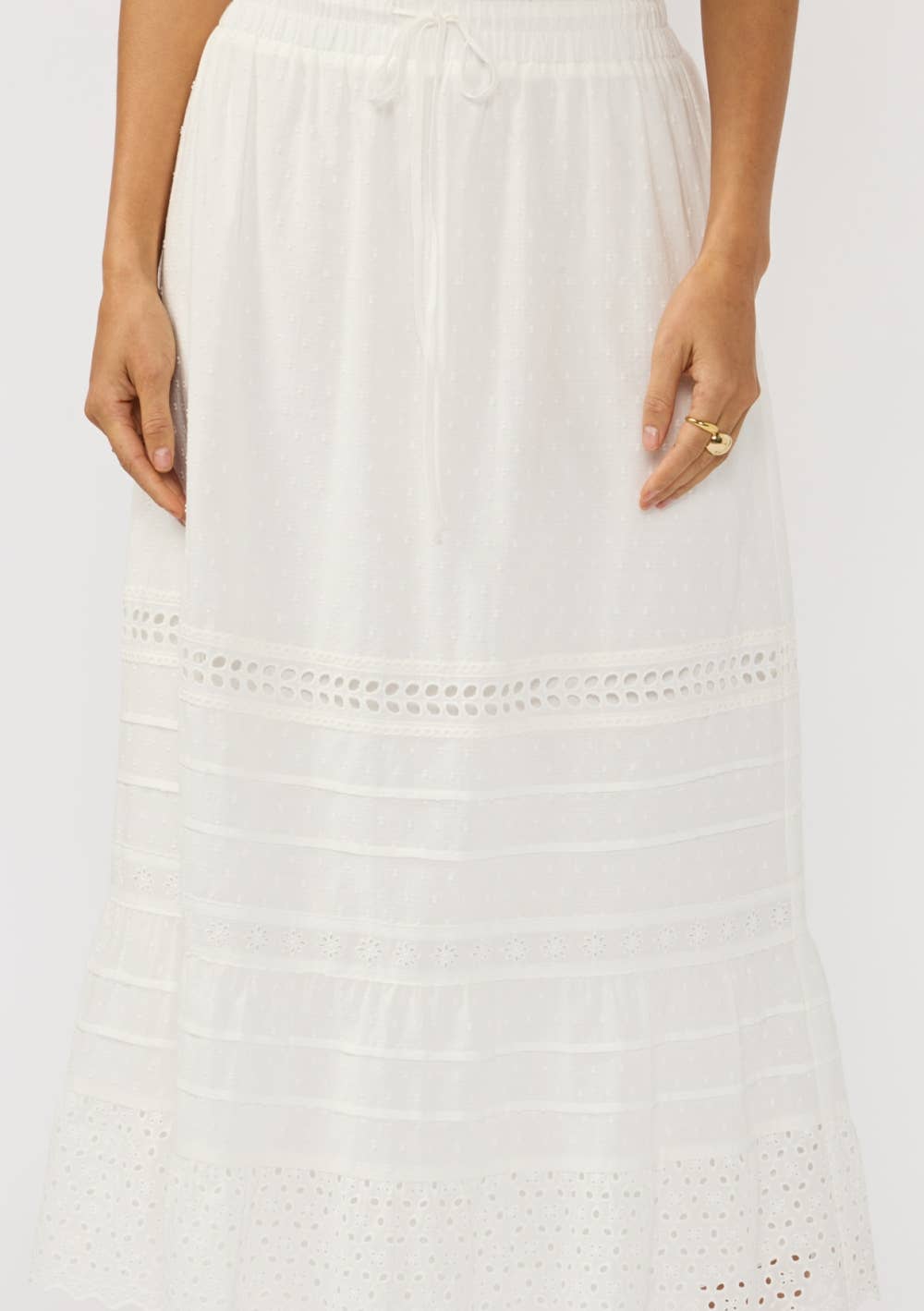 White Eyelet Hem Pintuck Skirt with drawstring waist and delicate textured and eyelet details for airy elegance.