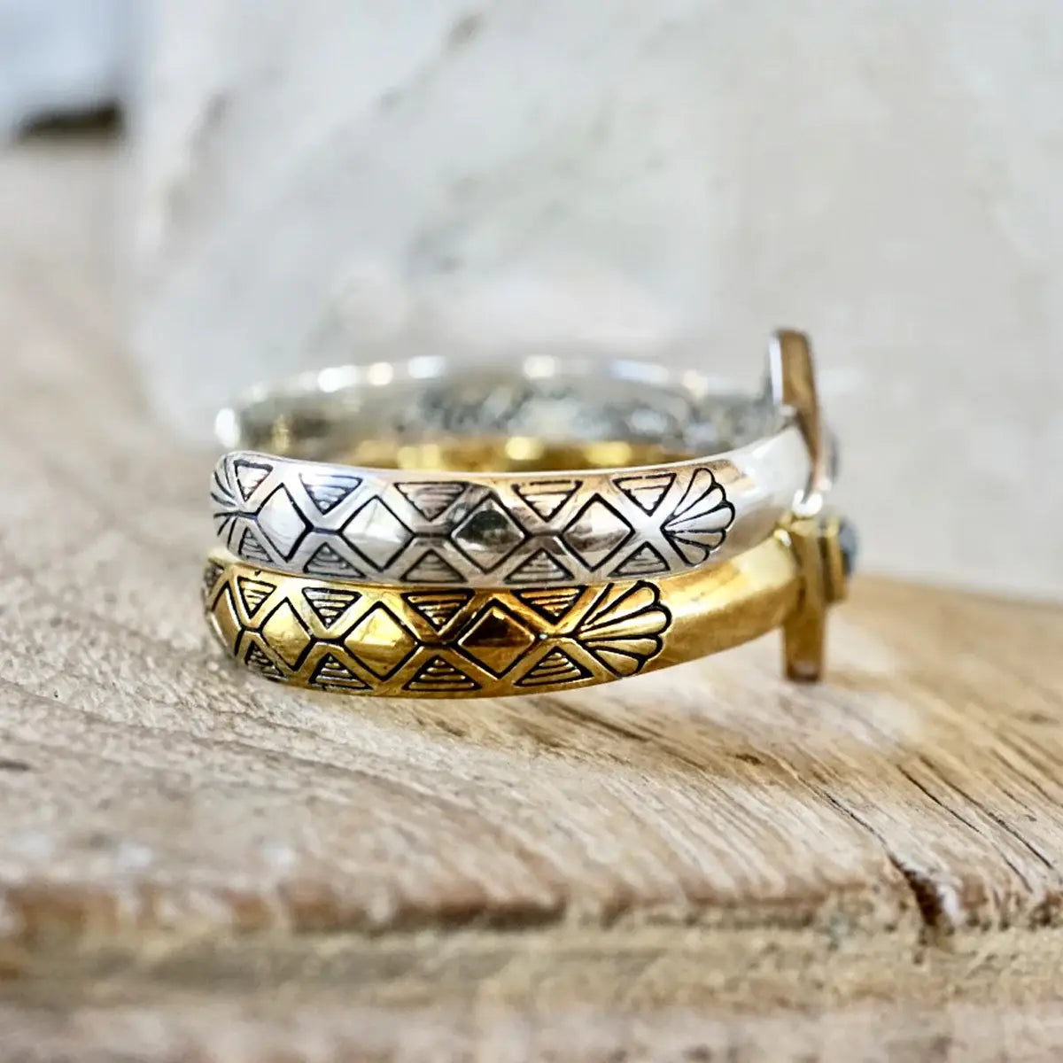 Hold Space Cuff featuring detailed engraved patterns in contrasting silver and gold tones for a bold statement piece.