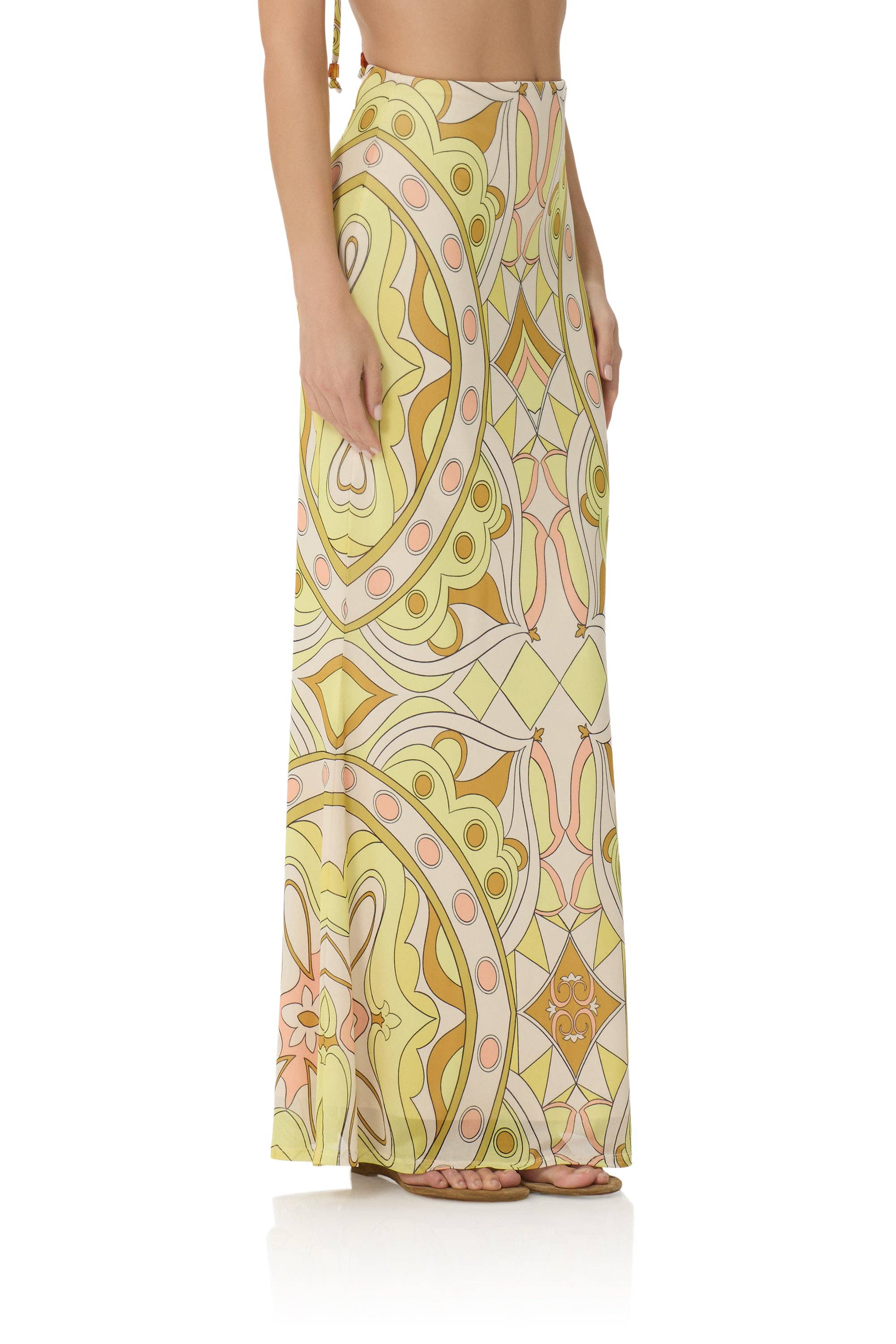 Woman wearing a flowing maxi skirt with pastel geometric patterns in shades of yellow and peach, Tegan Skirt - Geo Scarf