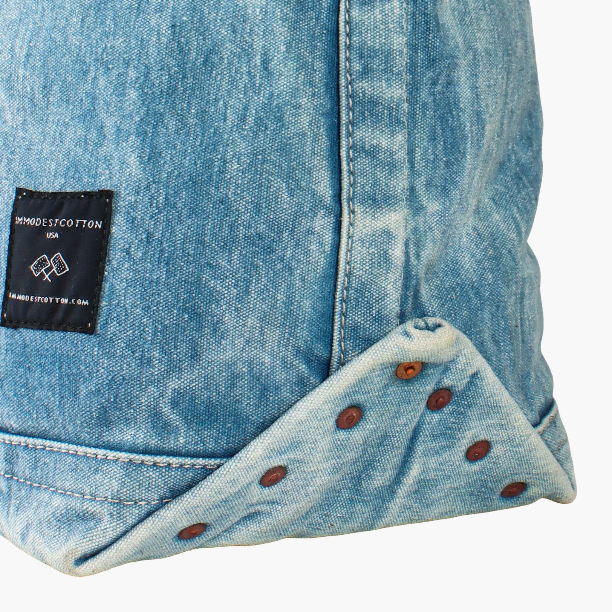Close-up of acid wash denim with rivet details on Electrician Tote | Acid Wash showcasing durable artisan design.