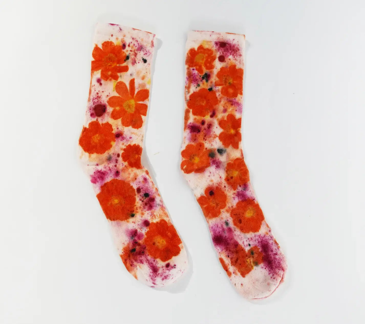 Flower Power Cotton Crew Sock with vibrant orange floral design and splashes of purple on soft white fabric.