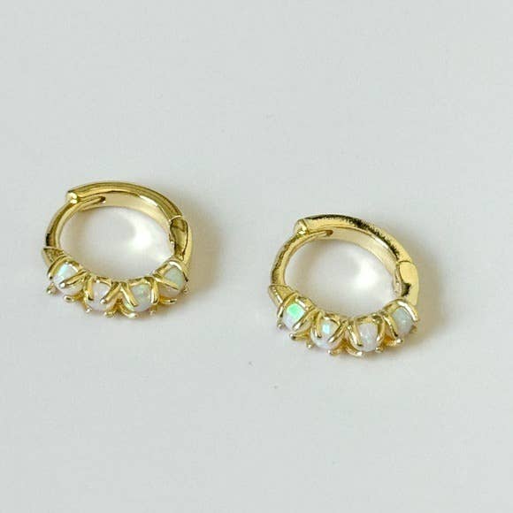 The Sonata Opal Hoops by Tramps+Thieves are gold-plated huggie earrings, each featuring five round opal stones set along the bottom edge, shown against a plain white background.