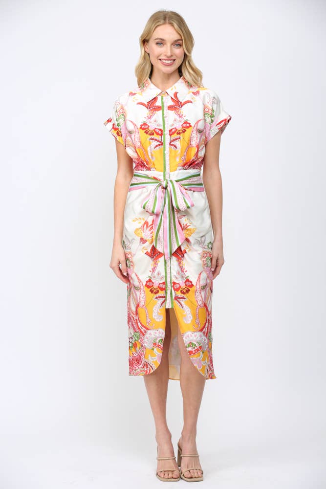 Woman wearing BOTANIC SCARF PRINT SELF TIE WAIST BUTTON DOWN DRESS with colorful bohemian floral patterns and green striped waist tie