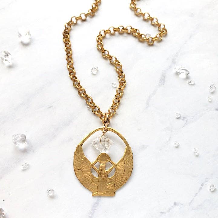 Winged Woman Egyptian Goddess Isis Brass Pendant Necklace with detailed wings on a gold chain against a marble background