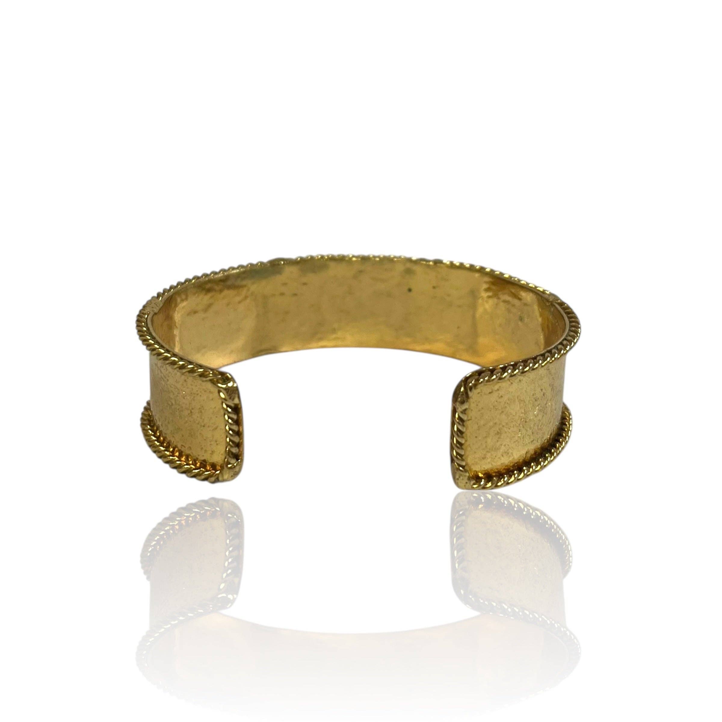 Smoky Quartz Gem Cuff in polished gold-tone metal with textured braided edges and open center design.