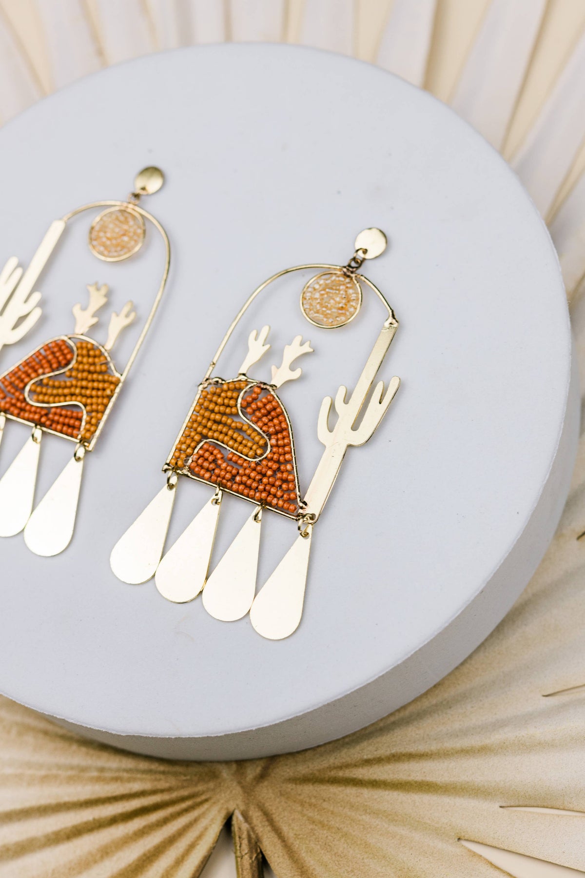 Sonora Sunrise artisan earrings with orange beaded cactus and sunburst details