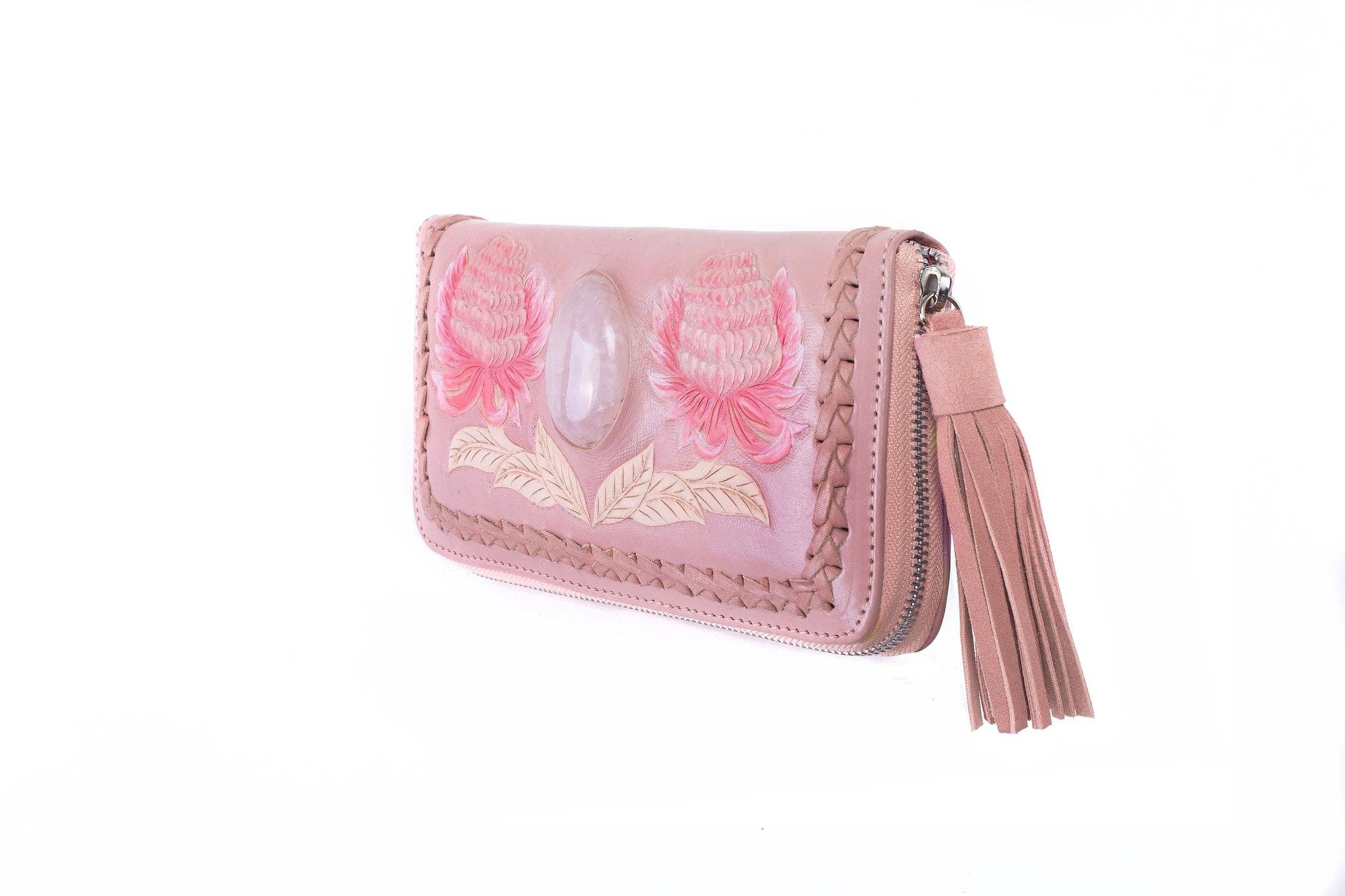 The Jodi Lee Wild Waratah Wallet Pink is a hand-tooled leather wallet with braided edges, a large tassel zipper, floral embroidery, and a genuine Rose Quartz gemstone on the front.