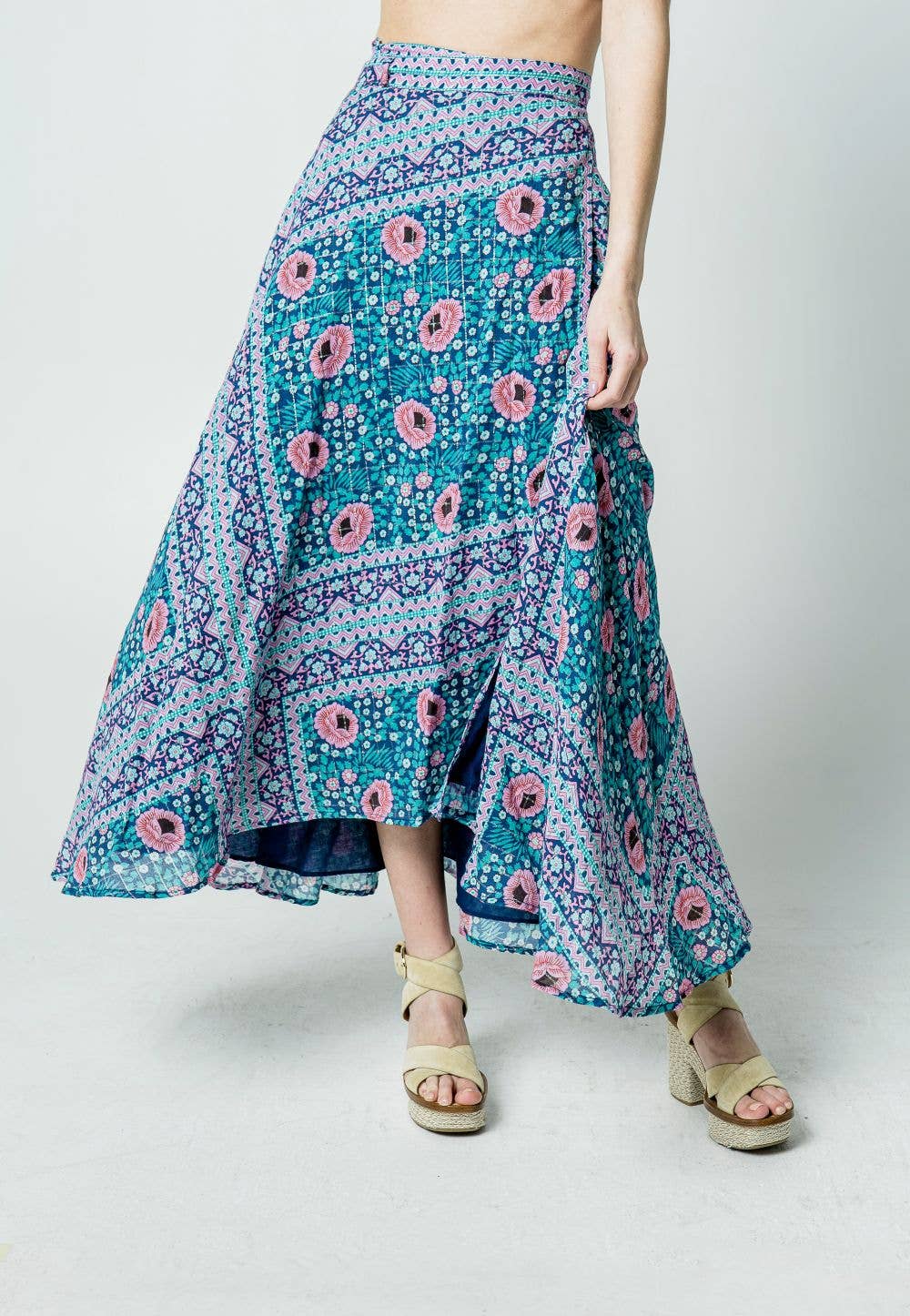 Blue and pink floral Glendora Wrap Skirt styled with beige heeled sandals on a model against plain background