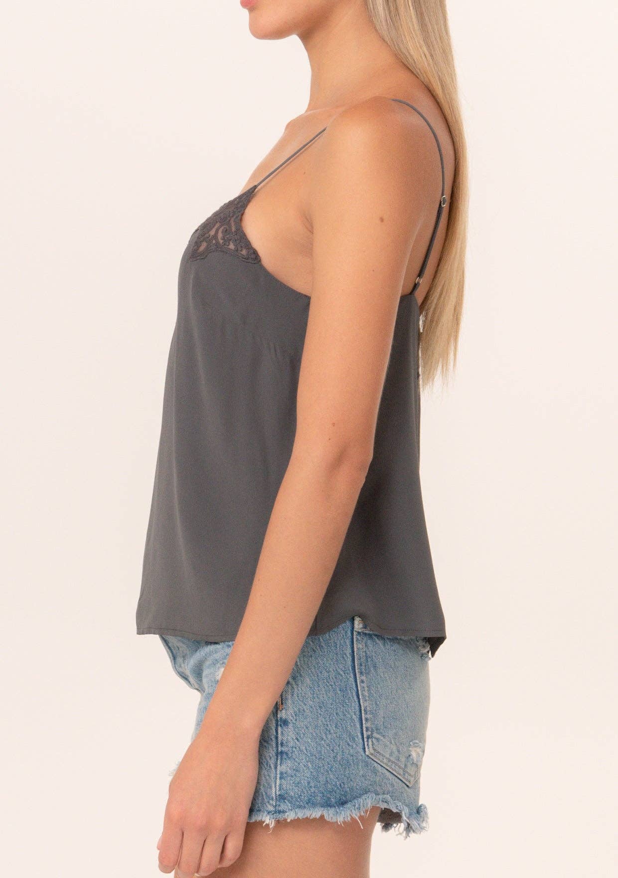 Side view of a woman wearing a Button Back Embroidered Lace Cami with denim shorts, showcasing delicate lace details.