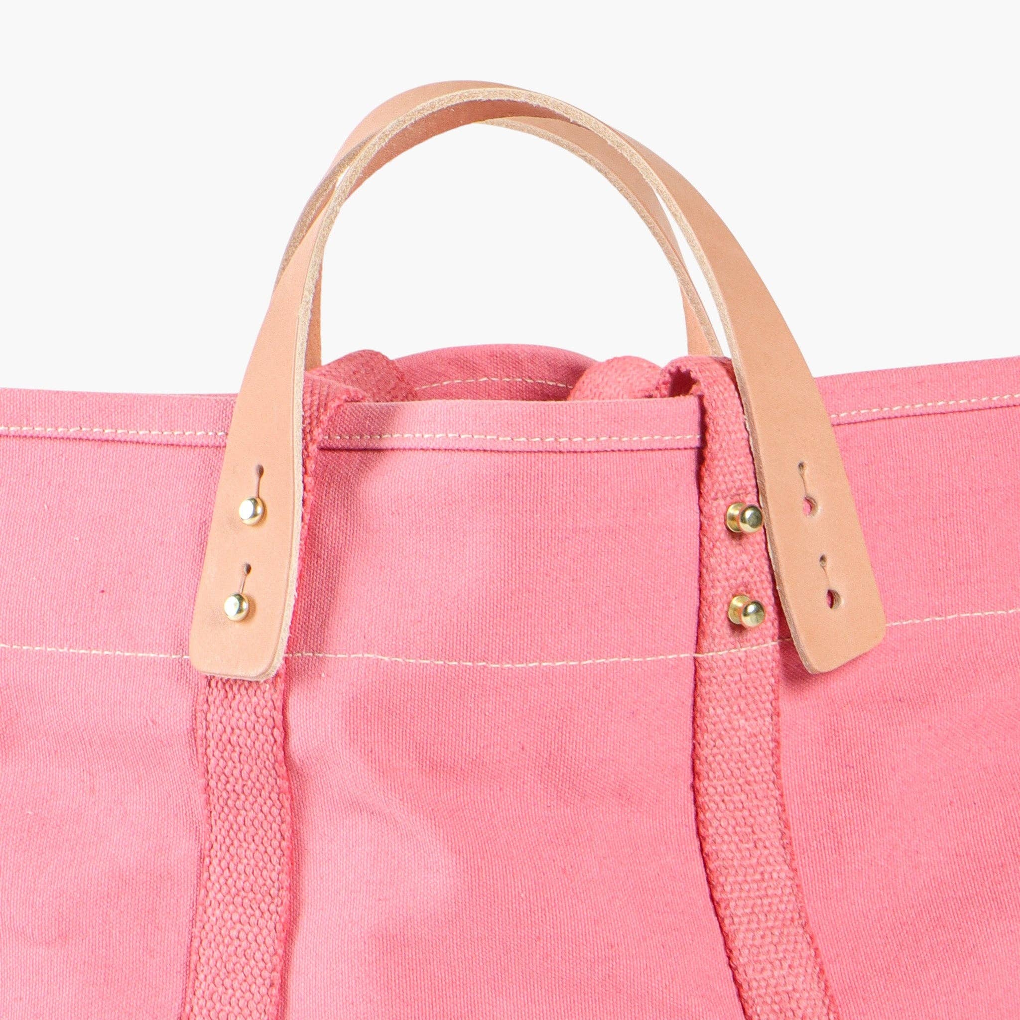 Small East West Tote | Flamingo with pink canvas fabric and natural leather handles with brass rivets close-up detail
