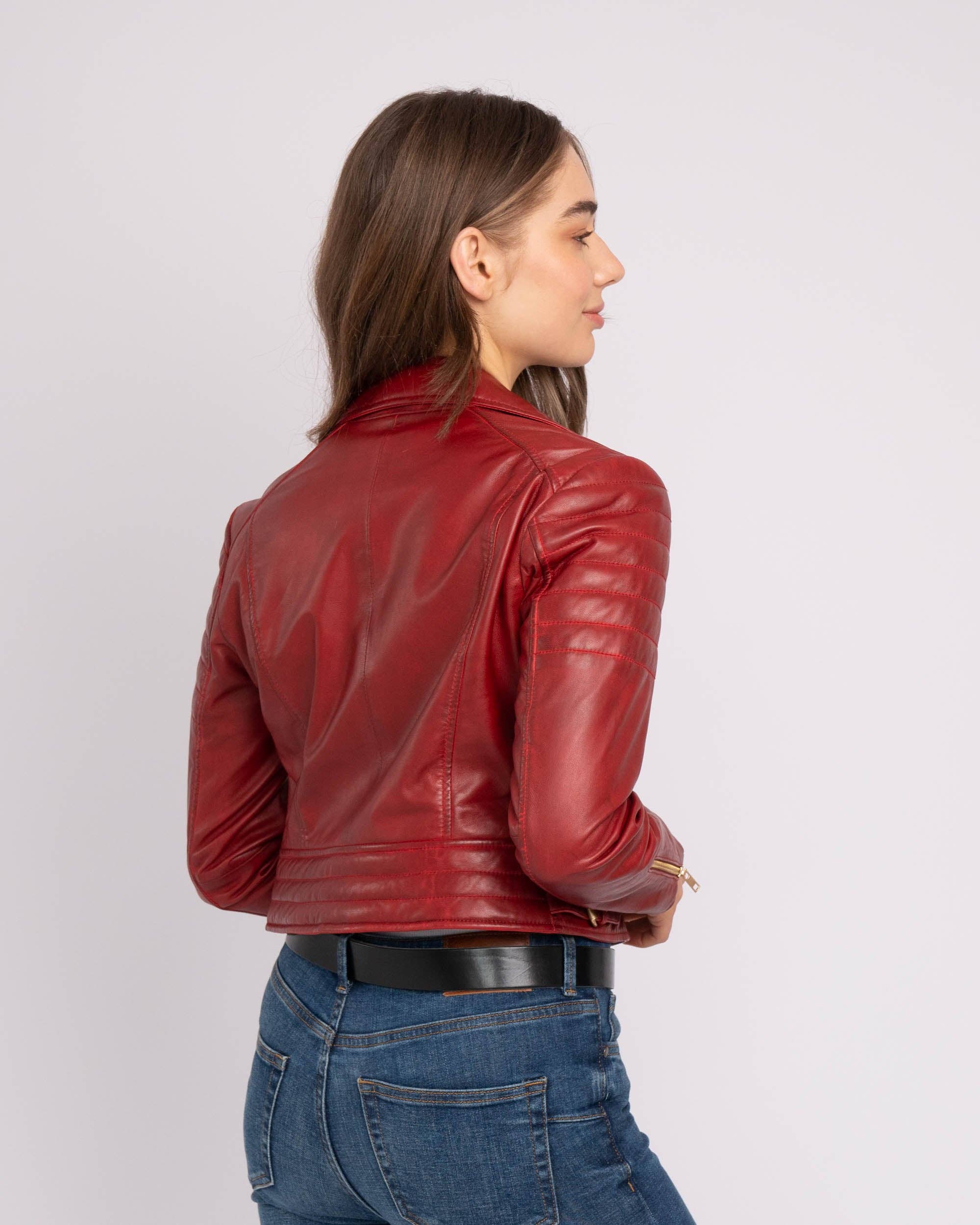 Woman wearing a vibrant red Eureka | Leather Biker Jacket shown from the back with stitched shoulder details