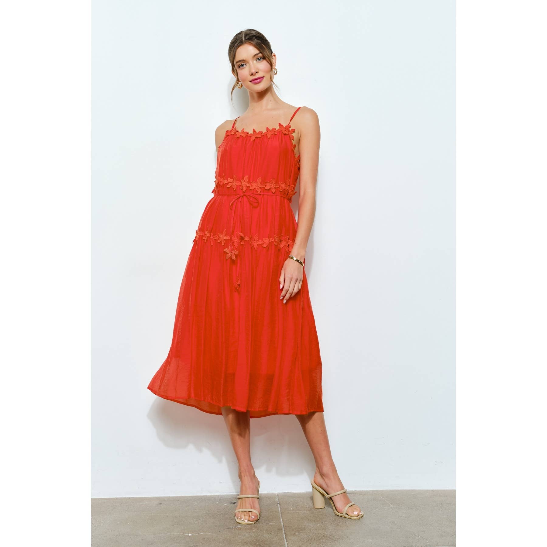 Woman wearing a red dress against a white background
