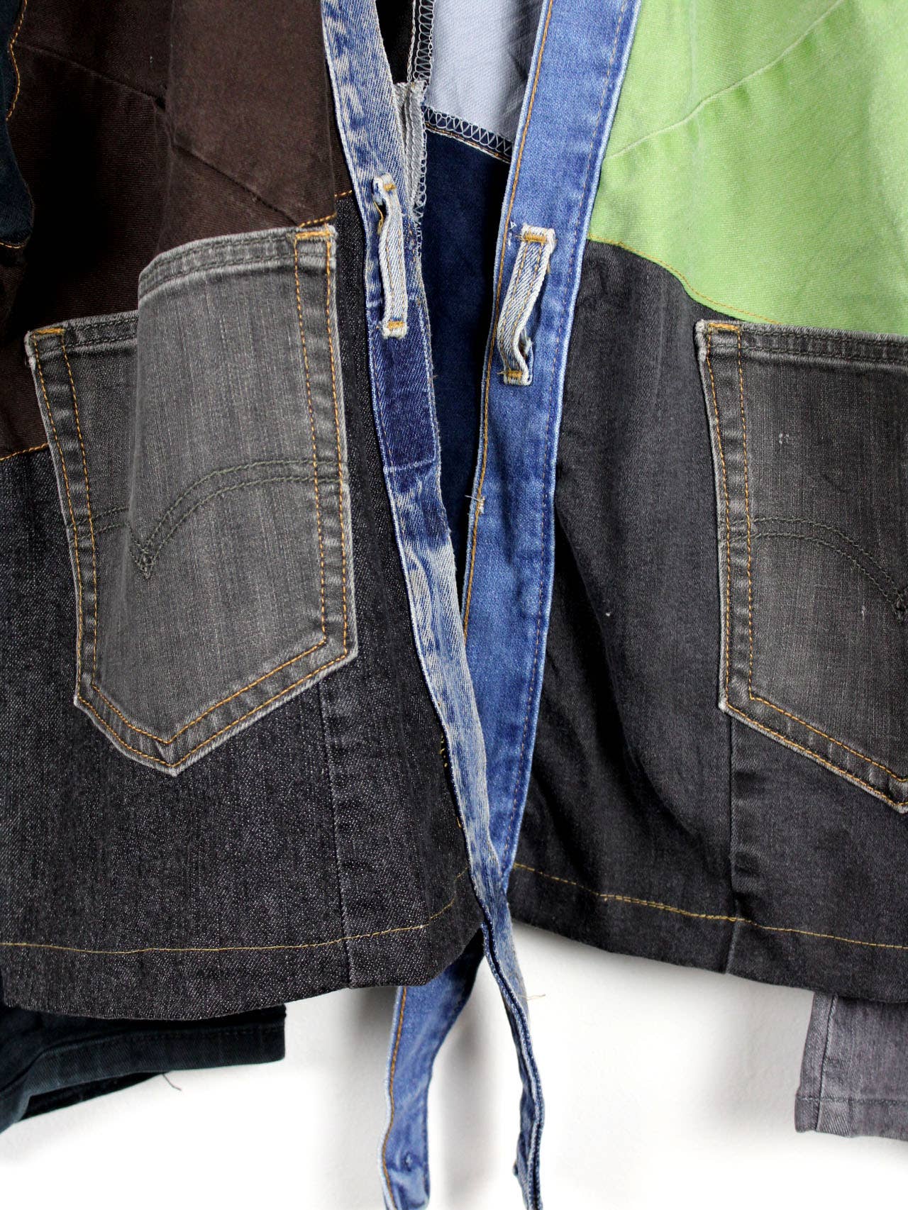 Close-up of pockets and patch details on an Upcycled Patchwork Denim Jacket with mixed denim and fabric panels