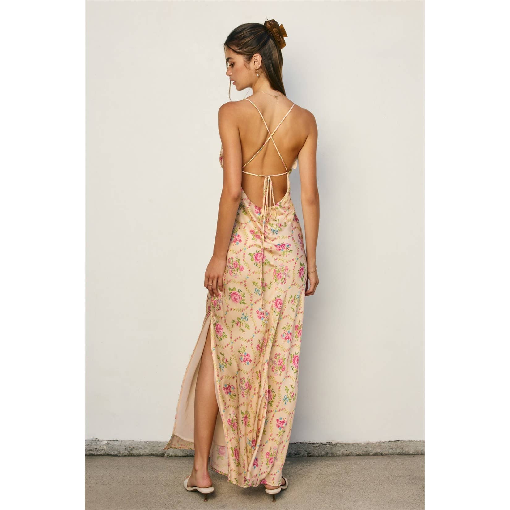 Woman wearing Eternal Afternoon Ruffled Triangle Bust Maxi Dress with floral print and open back strappy design.