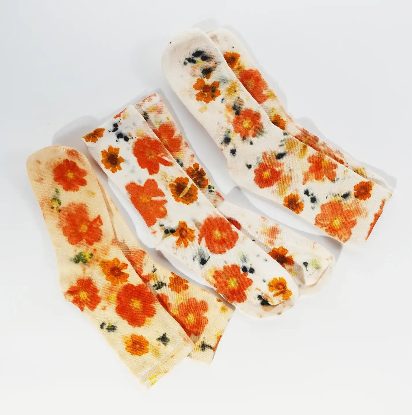 Four pairs of Flower Power Cotton Crew Sock featuring vibrant orange floral patterns on soft cotton fabric.