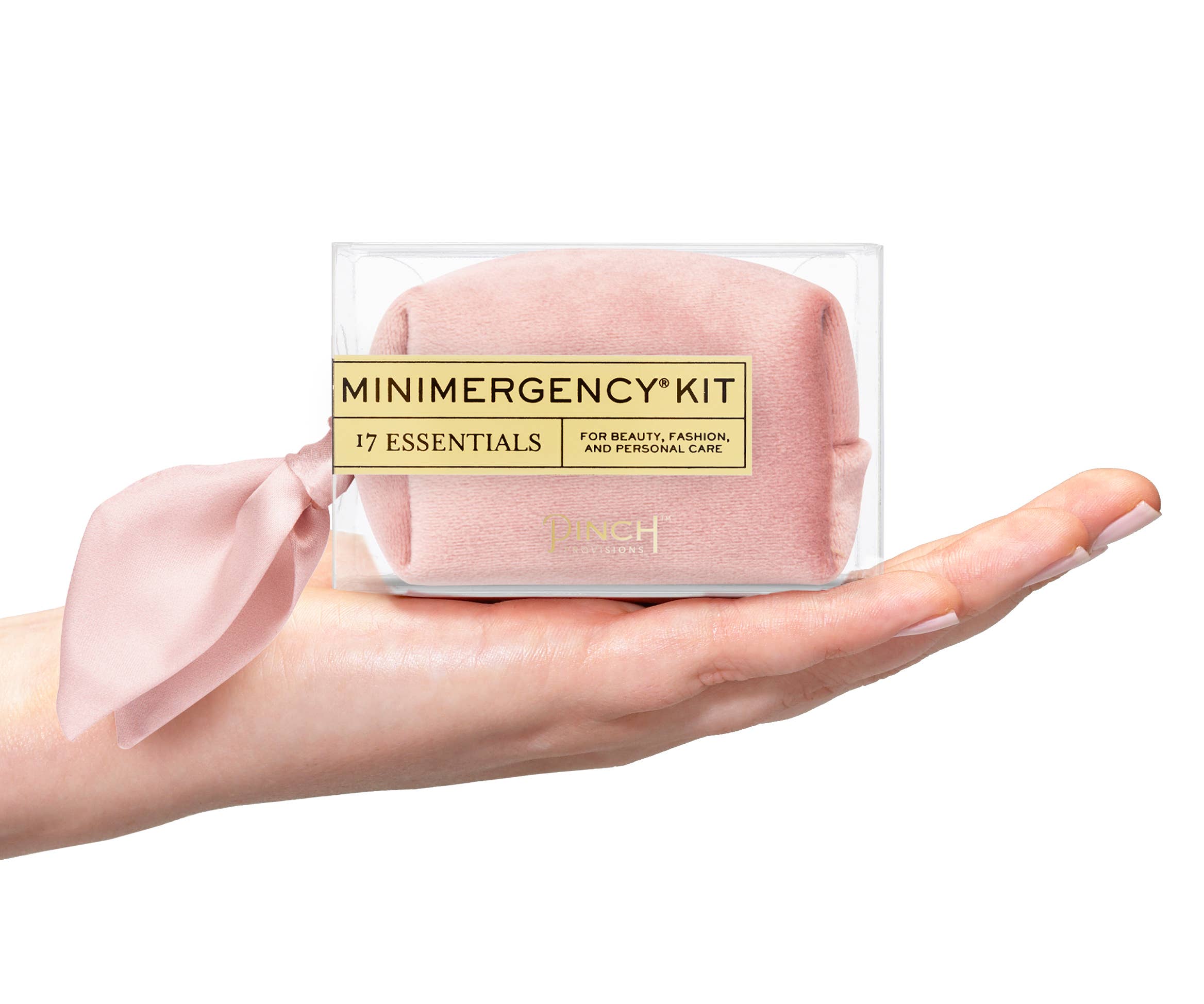 Velvet Scarf Minimergency Kit held on hand showing soft pink pouch with 17 essentials for beauty and personal care