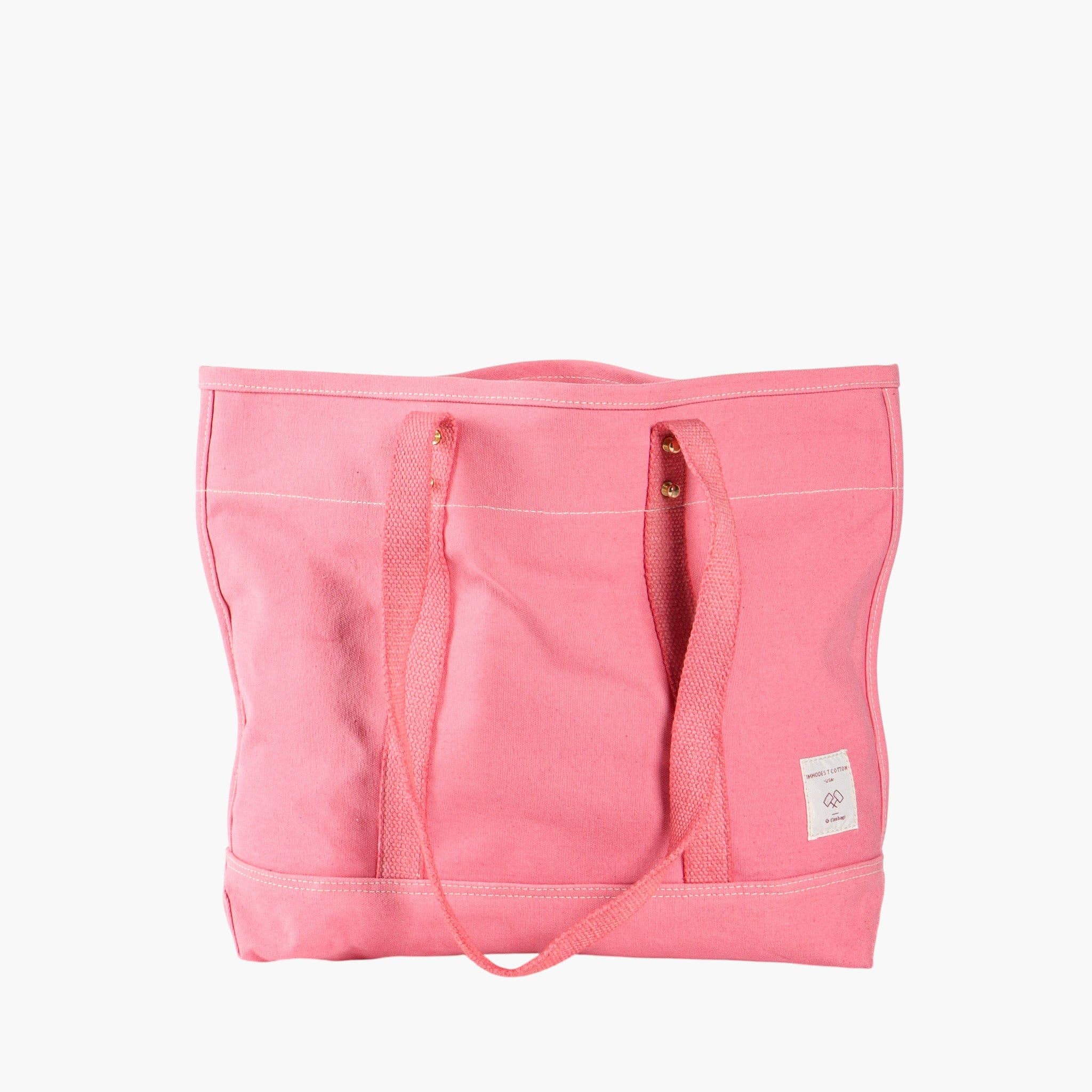 Small East West Tote | Flamingo in vibrant pink canvas with sturdy handles and minimalist design for everyday use