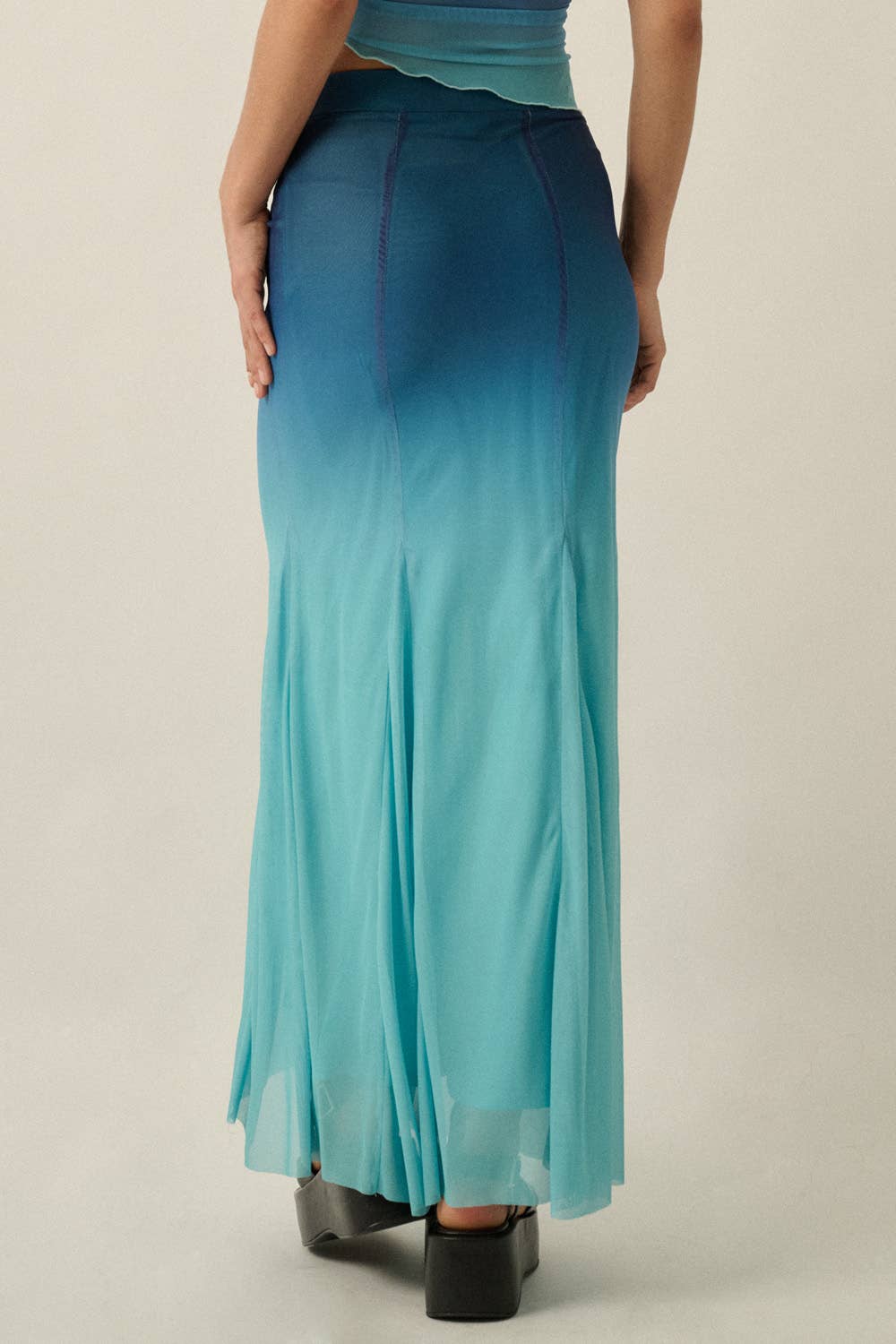 Back view of Ombre Mesh Fit-and-Flare Godet Maxi Skirt in gradient blue shades with sheer fabric panels.