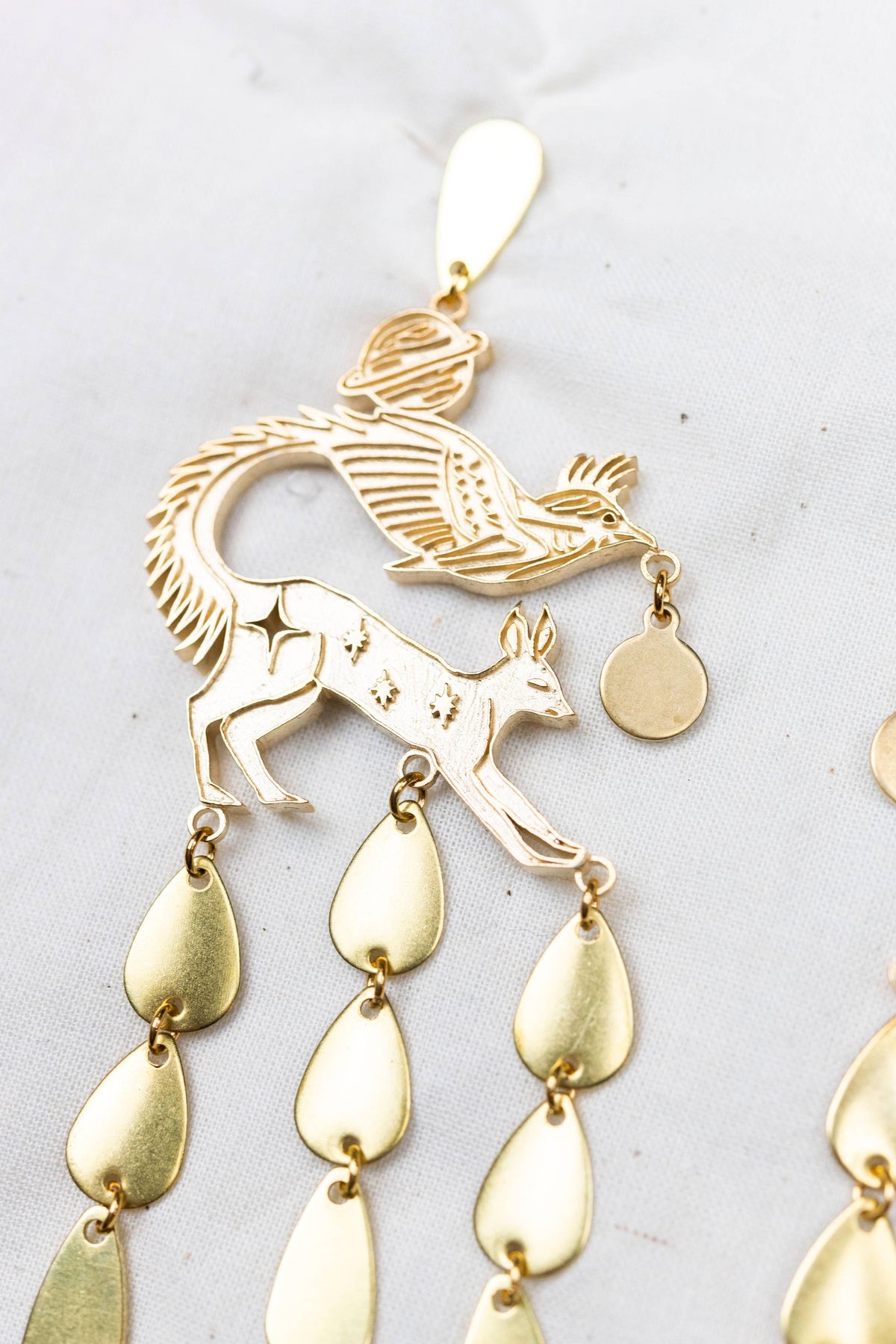Quilinx gold statement earrings with bird and deer motifs and teardrop drops