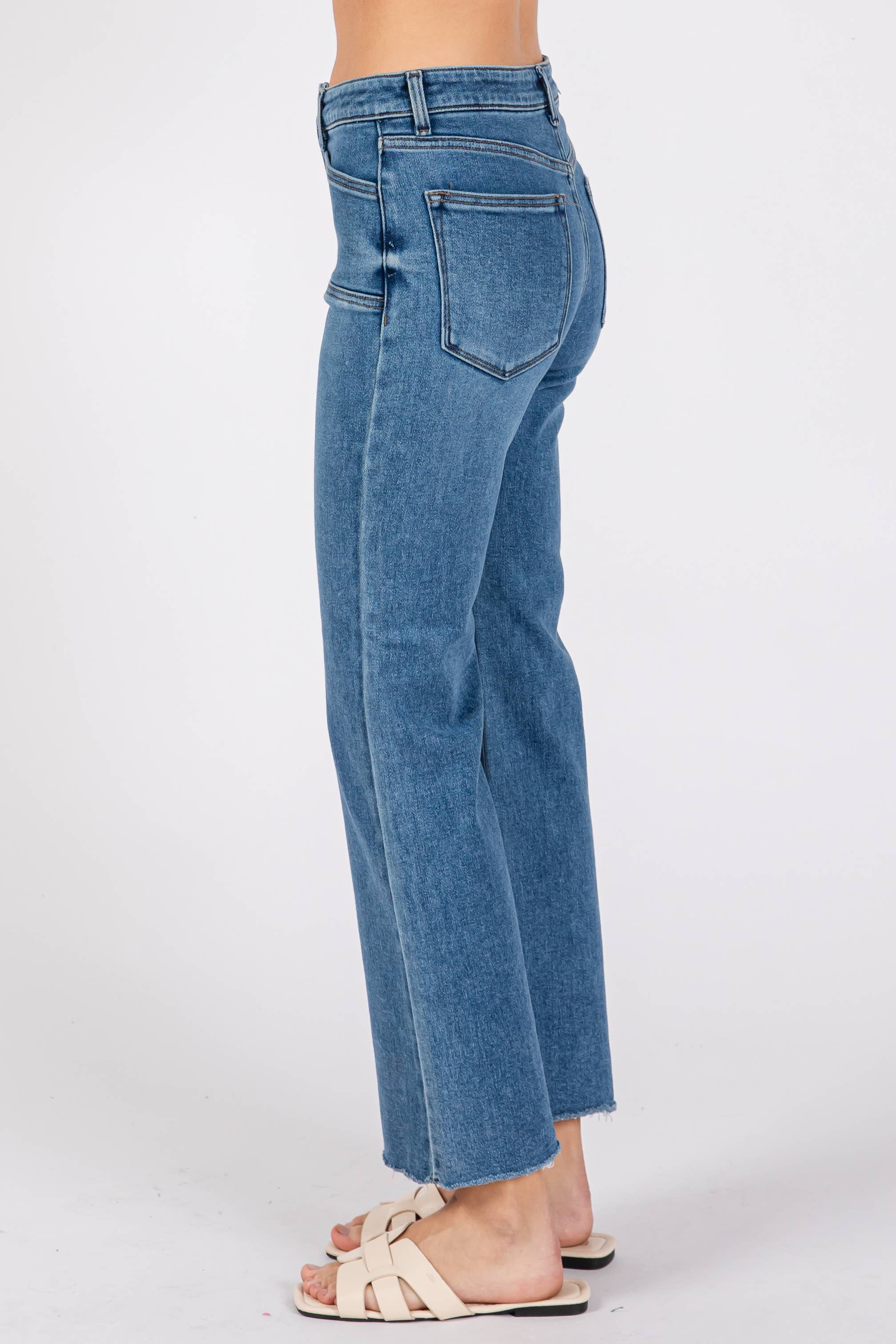 Side view of Medium Sicily Jean Square Pocket in classic blue denim with a straight leg and raw hem detailing.