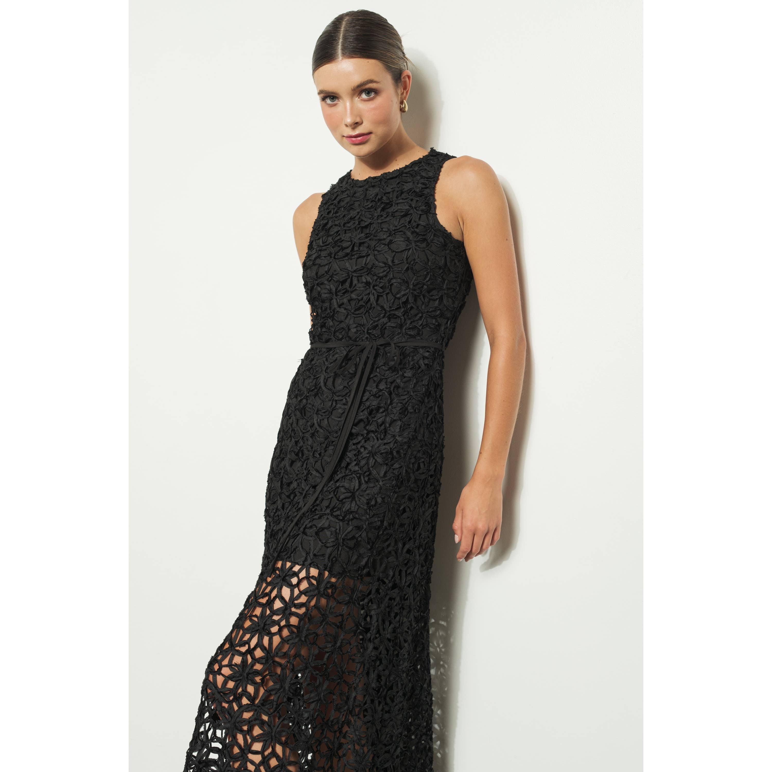 A woman wearing the INA Sleeveless Crochet Lace Overlay Midi Dress stands against a white background, looking at the camera with her hair tied back.