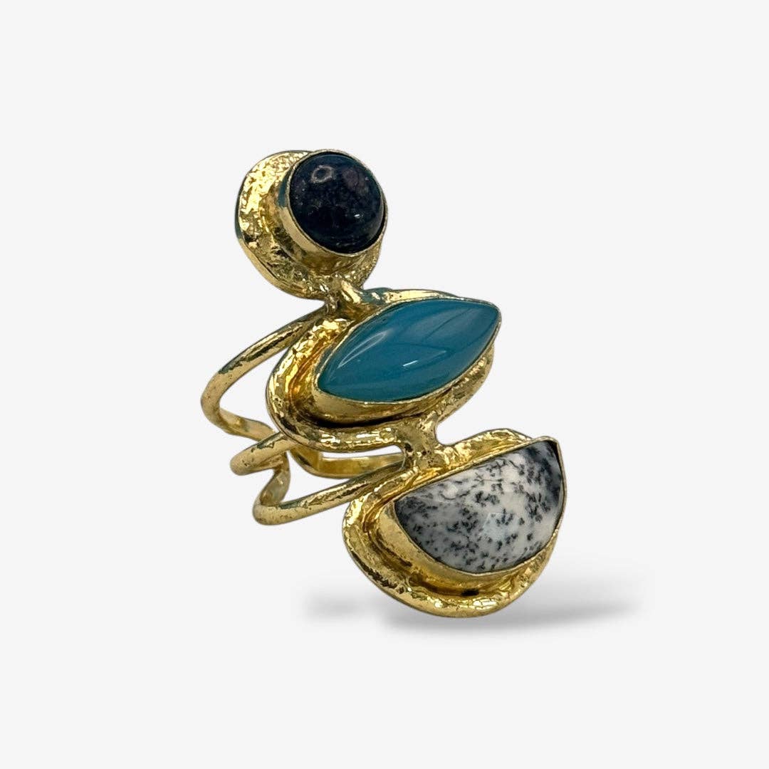 Cocktail Rings featuring hammered gold with black, teal, and white marbled stones in a bold statement design