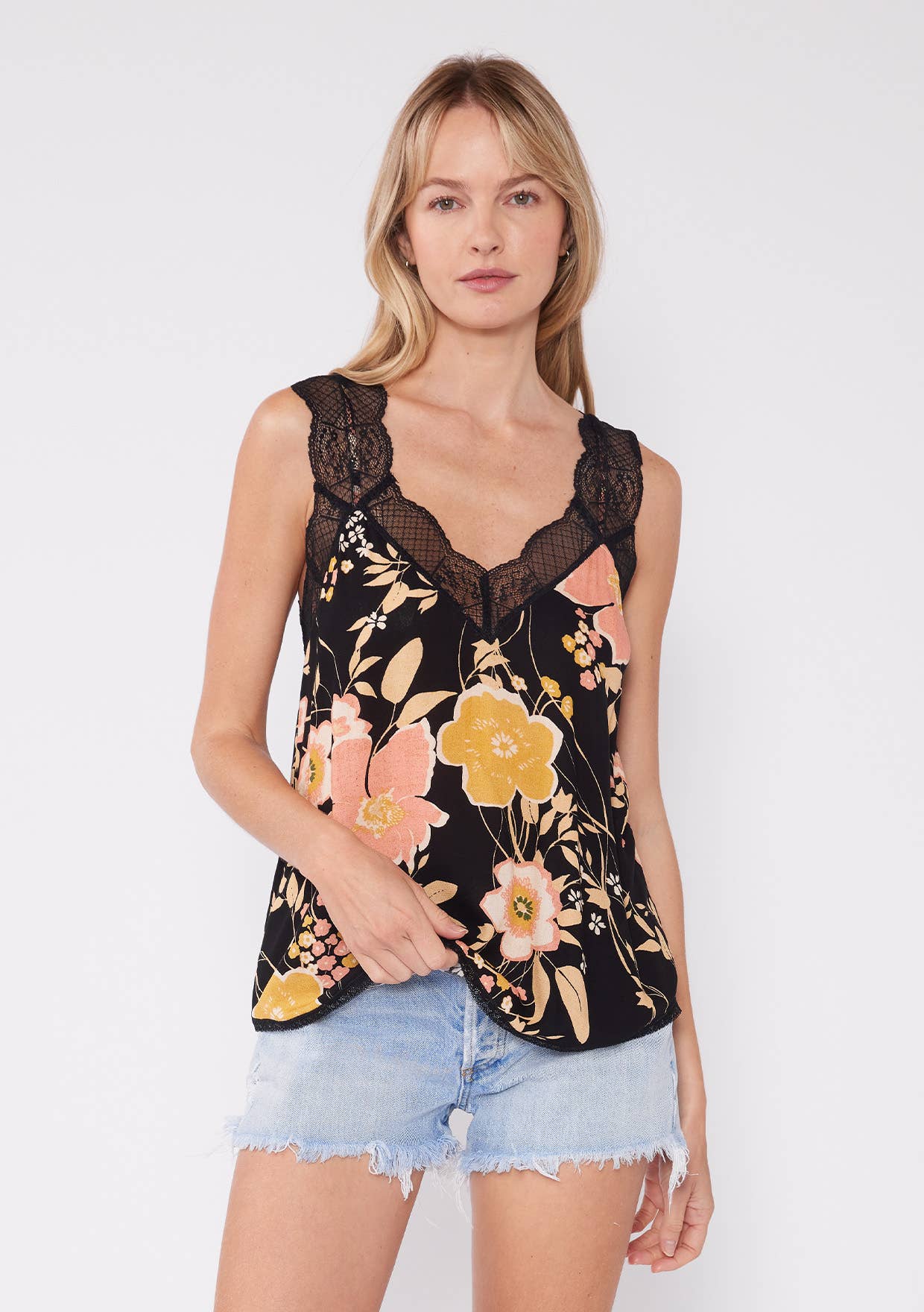 Woman wearing Floral Scallop Lace Trim V Neck Tank Top with black lace and floral print paired with denim shorts