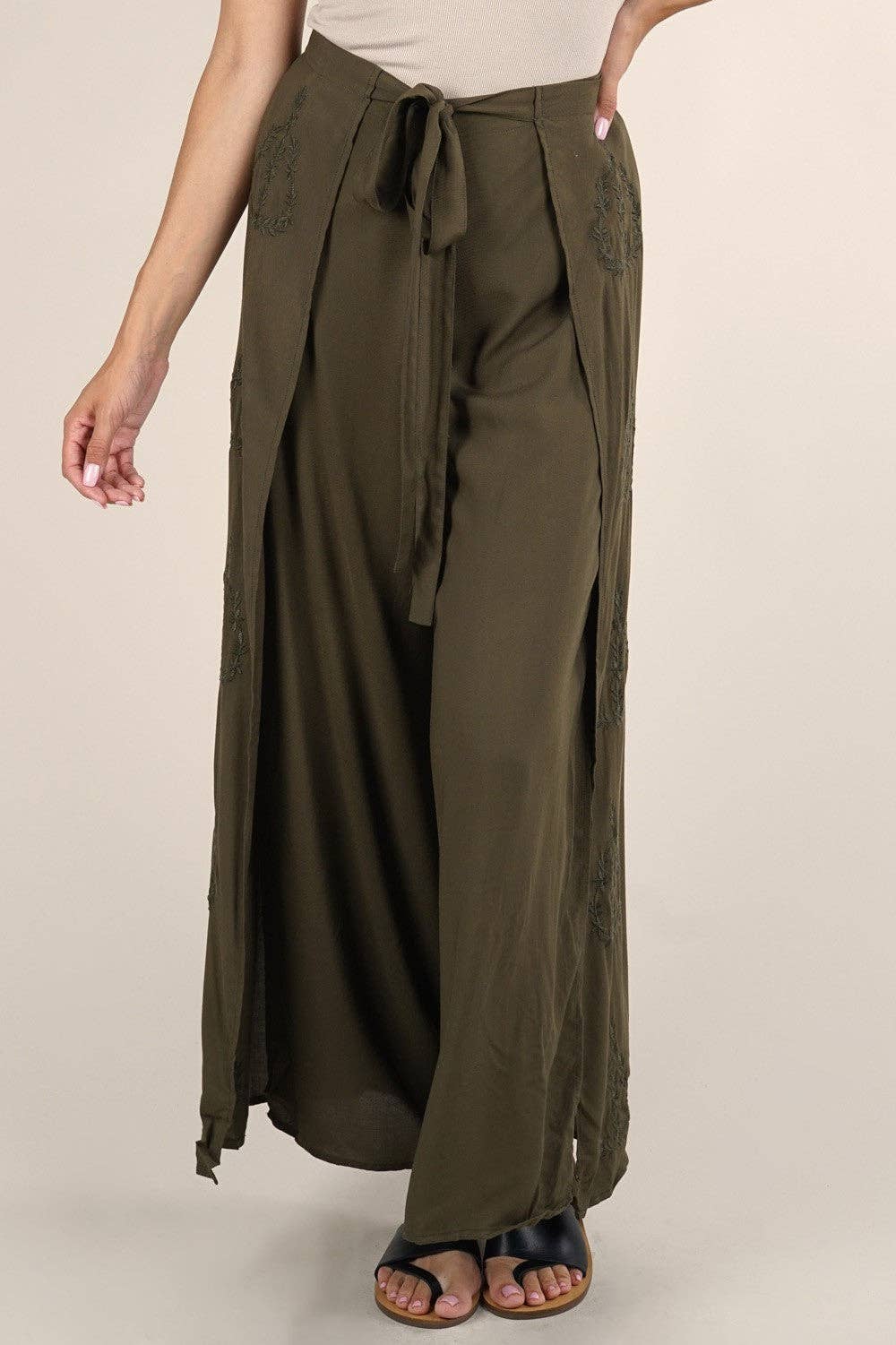 Woman wearing olive green Boho Beach Light Weight Wrap Pant with side ties and relaxed fit styled with sandals