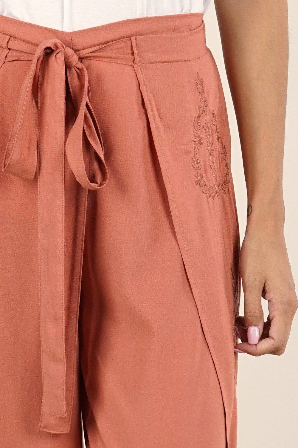 Close-up of rust-colored Boho Beach Light Weight Wrap Pant with tied waist and subtle embroidery detail on side.