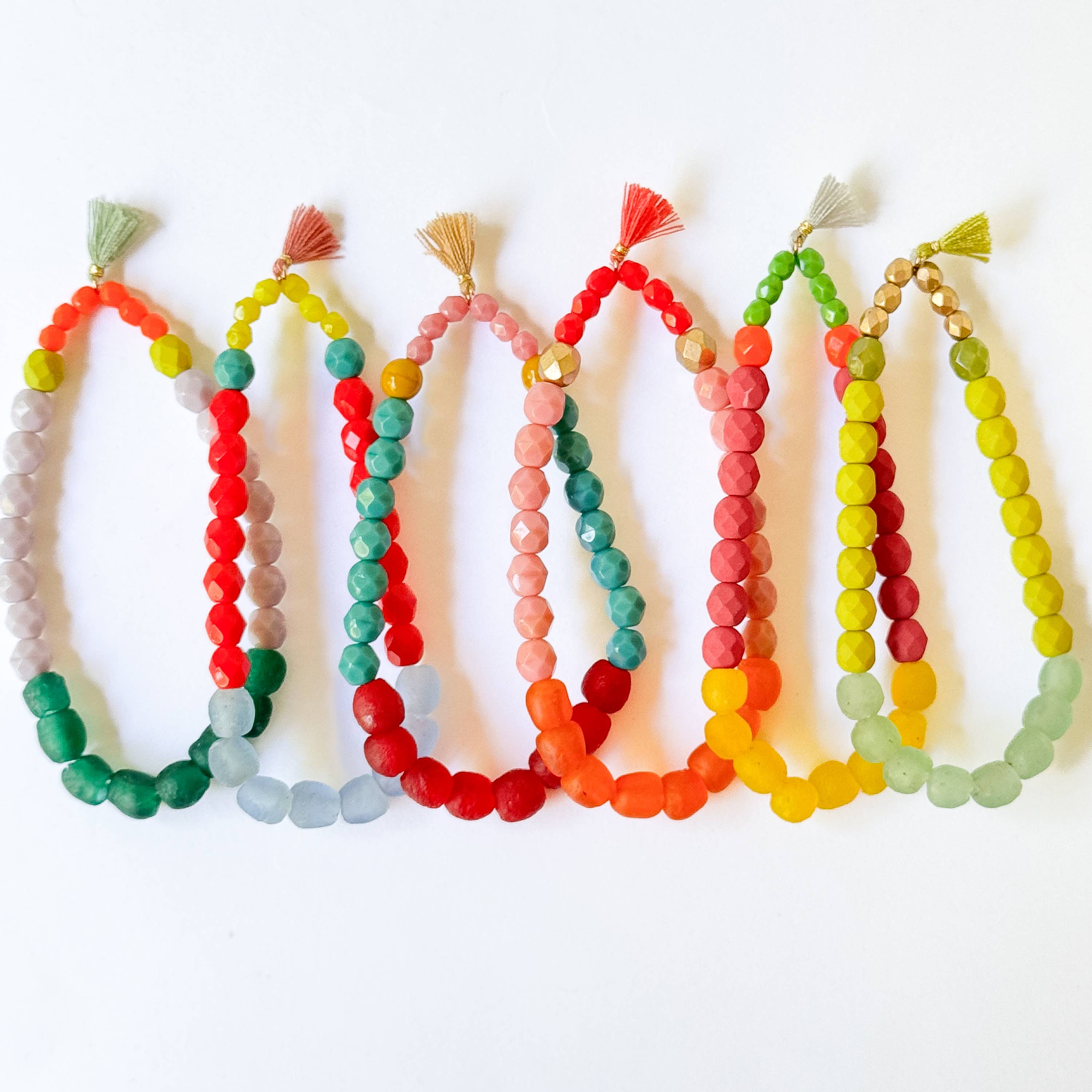 Multicolor Recycled African Glass And Mixed Bead Bracelet in vibrant colors with tassel accents for boho style accessories