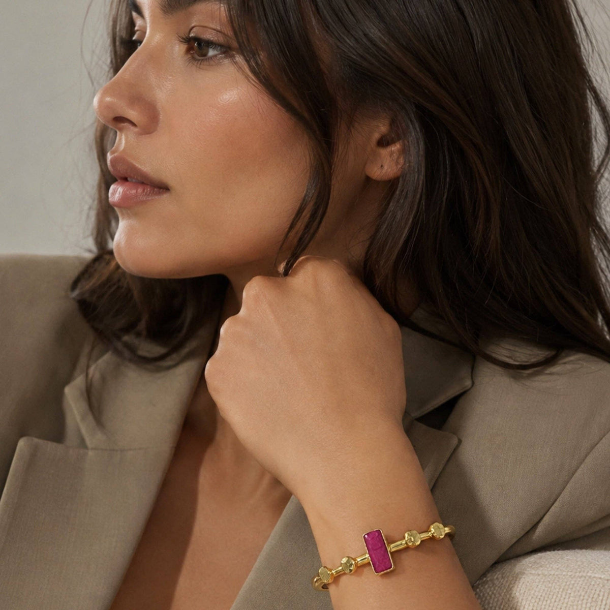 Harem Ruby Bangle with gold beads and a ruby red rectangular accent on a woman's wrist