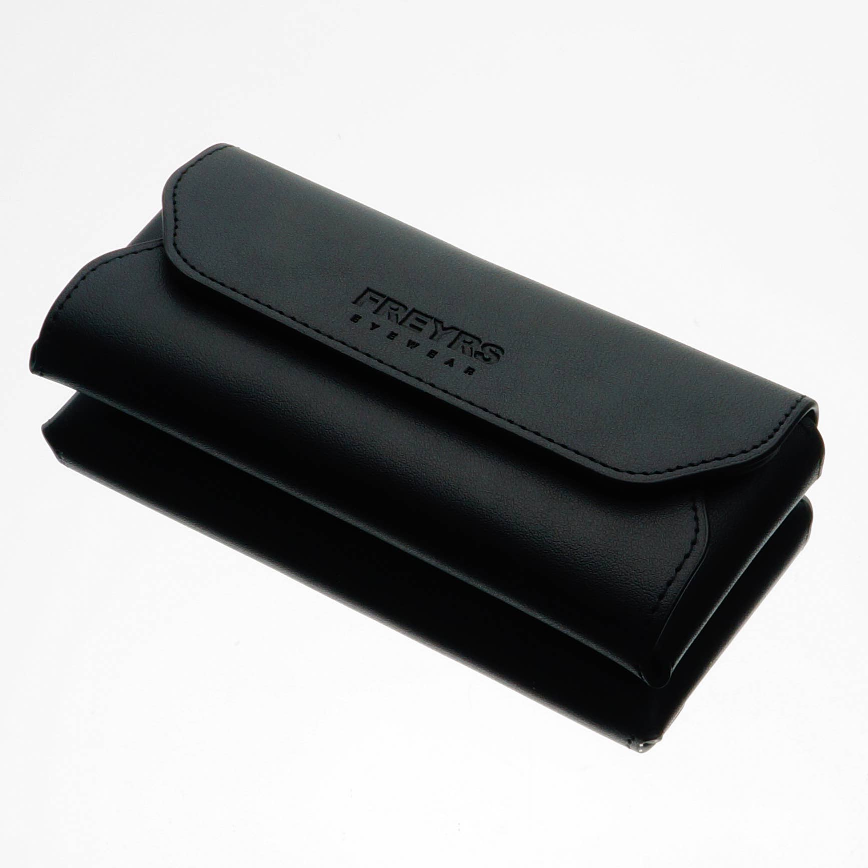 A black, rectangular FREYRS Eyewear case with a flap closure is displayed on a white surface—crafted to pair perfectly with the Billie (NEW) Unisex Aviator Sunglasses.