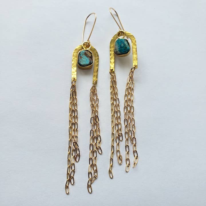 The Gold Rainbow Arch Chain Duster Earrings by Dreamers of Dreams feature hammered arches, turquoise stones, and cascading gold chains, shown on a white background.